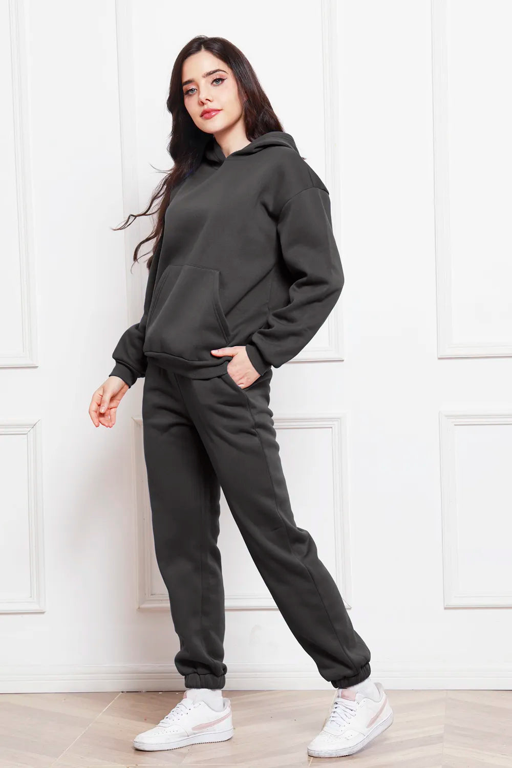Black drop-shoulder pullover hoodie and jogger pants set, drawstring hood, cuffed ankle joggers
