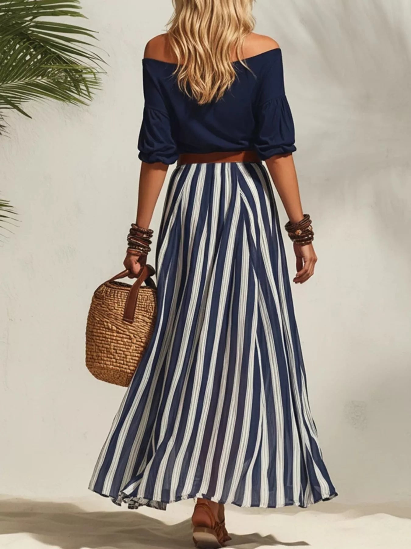 Navy off-shoulder top with navy-and-white striped maxi skirt, belted waist