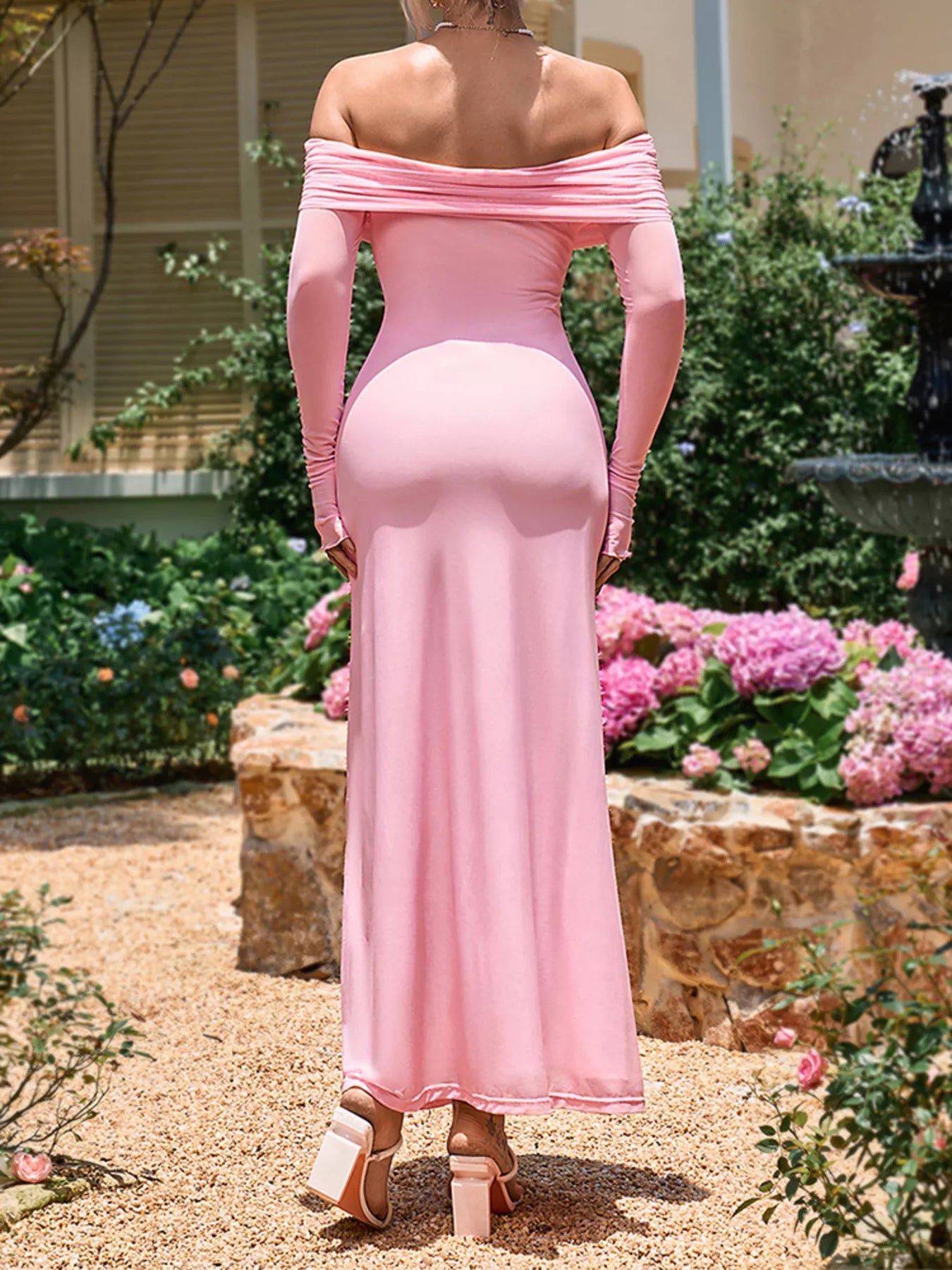 Pink off-shoulder ruched maxi dress with long sleeves and flowing ankle-length silhouette