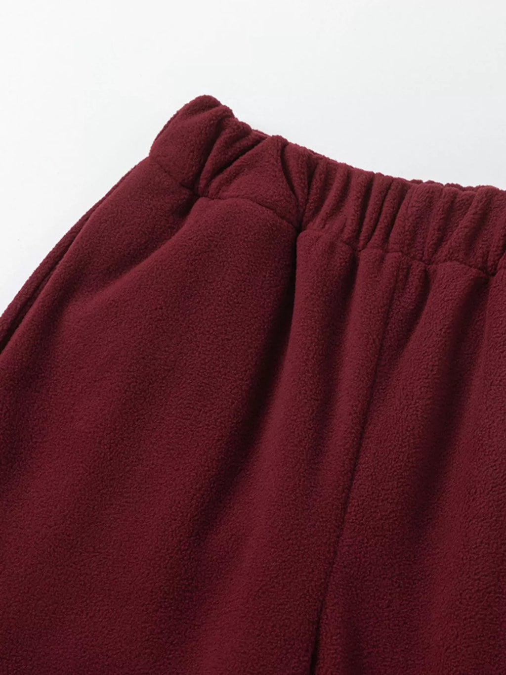 Burgundy jogger pants showing elastic waistband detail