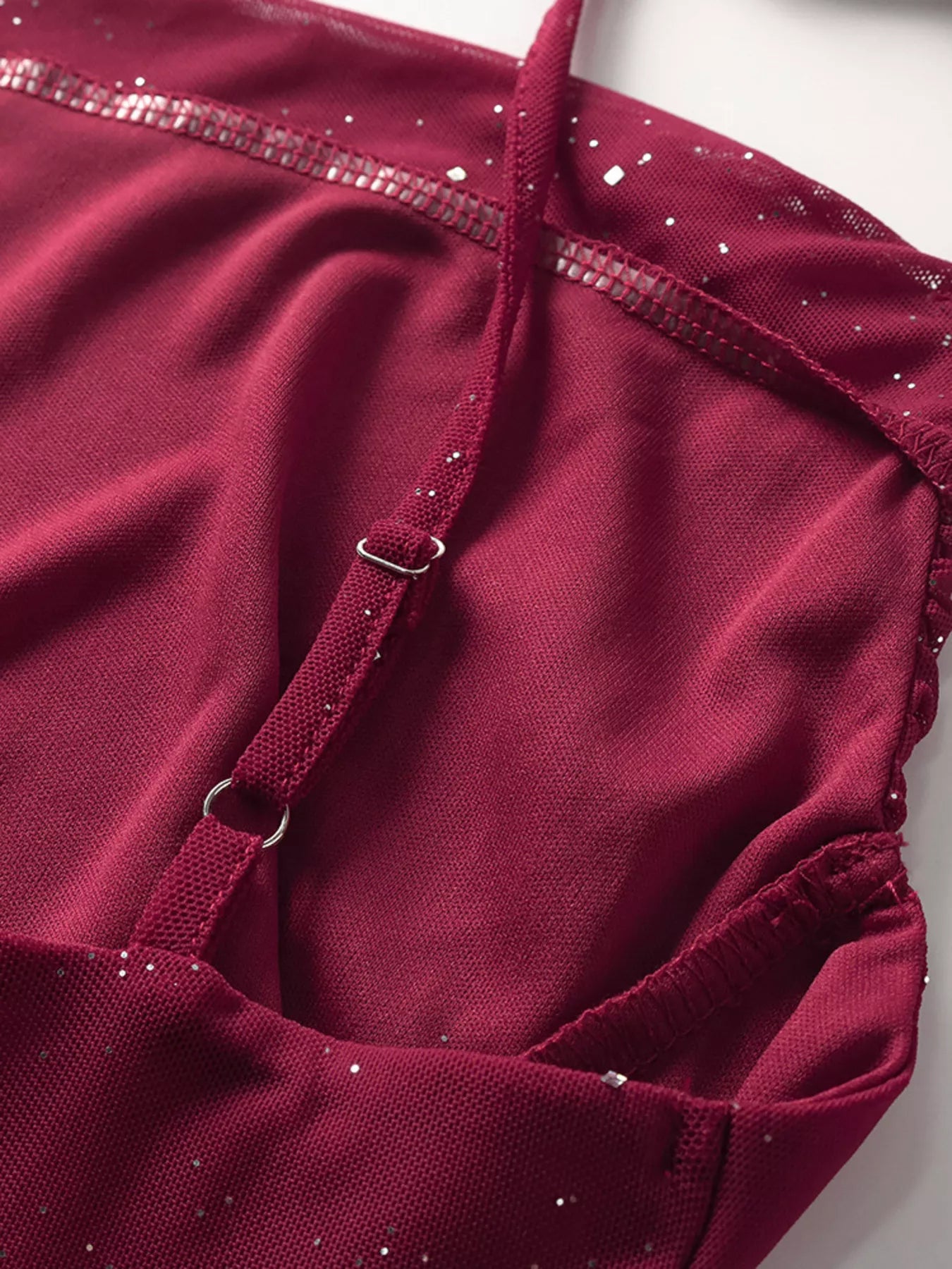 Close-up of burgundy glitter gathered waist with adjustable straps