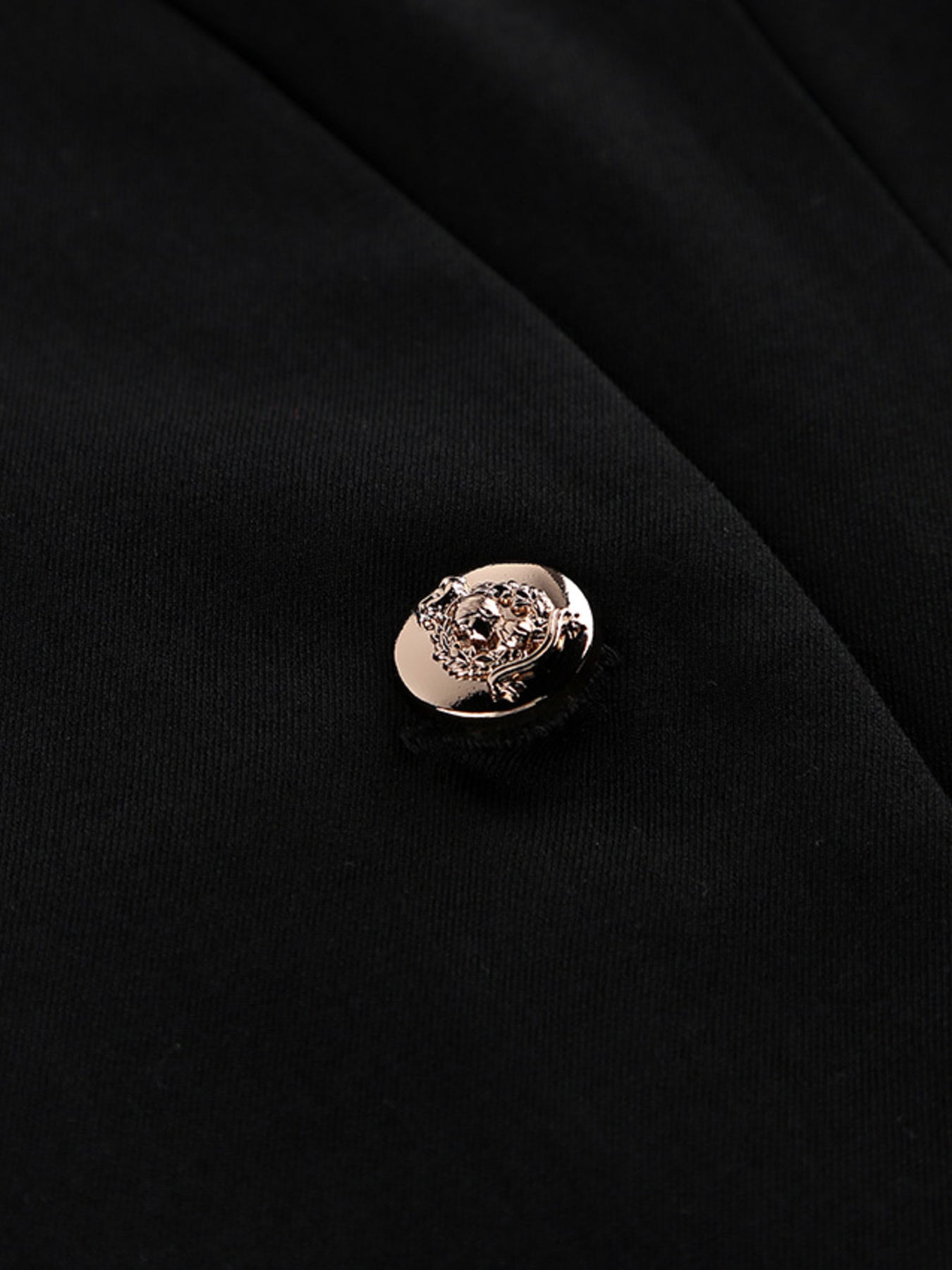 Black blazer dress with gold-tone decorative button at the center front