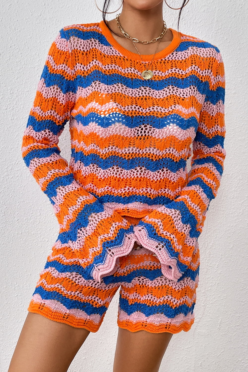 Striped knit sweater and shorts set, orange-red and blue wavy stripes, knit cutout detail.