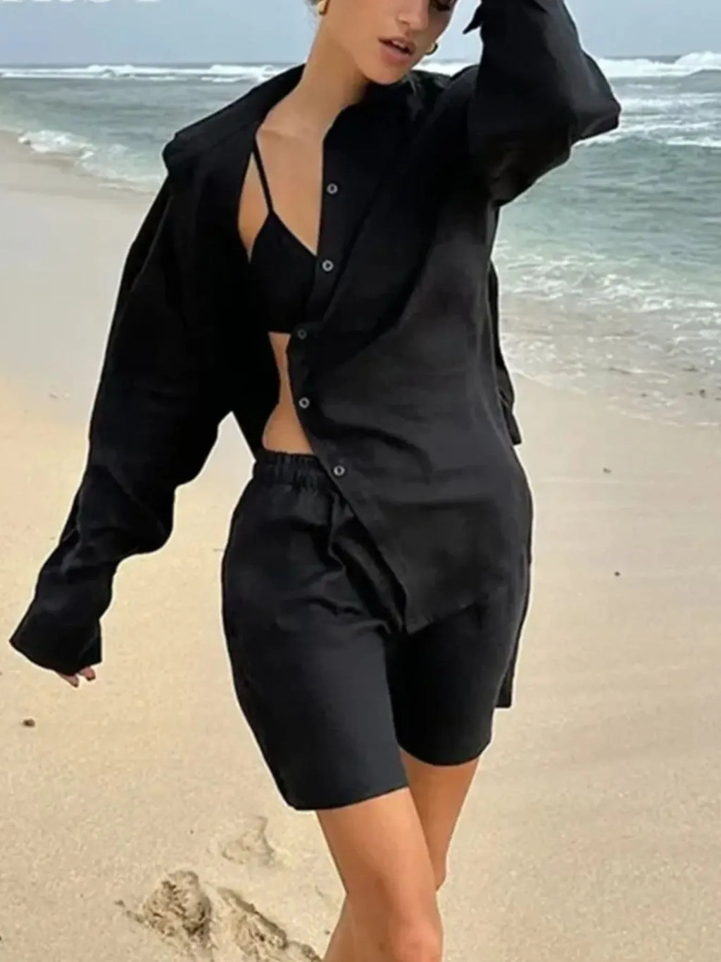 Black button-up long-sleeve shirt and matching elastic-waist shorts set, unbuttoned front