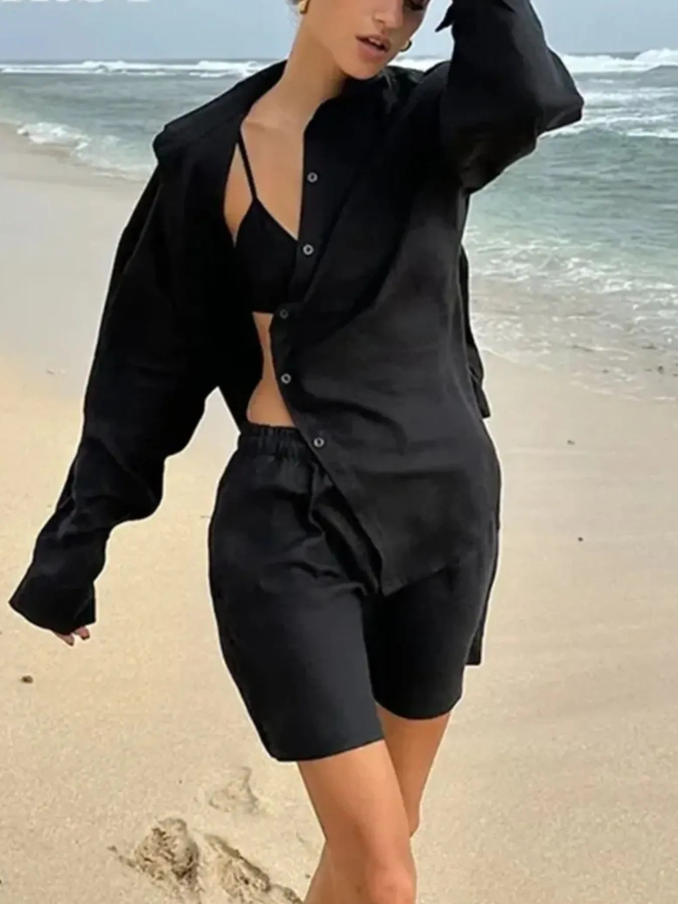 Black button-up long-sleeve shirt and matching elastic-waist shorts set, unbuttoned front