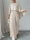 Cream cape pleated maxi dress with draped cape sleeves and vertical pleated skirt