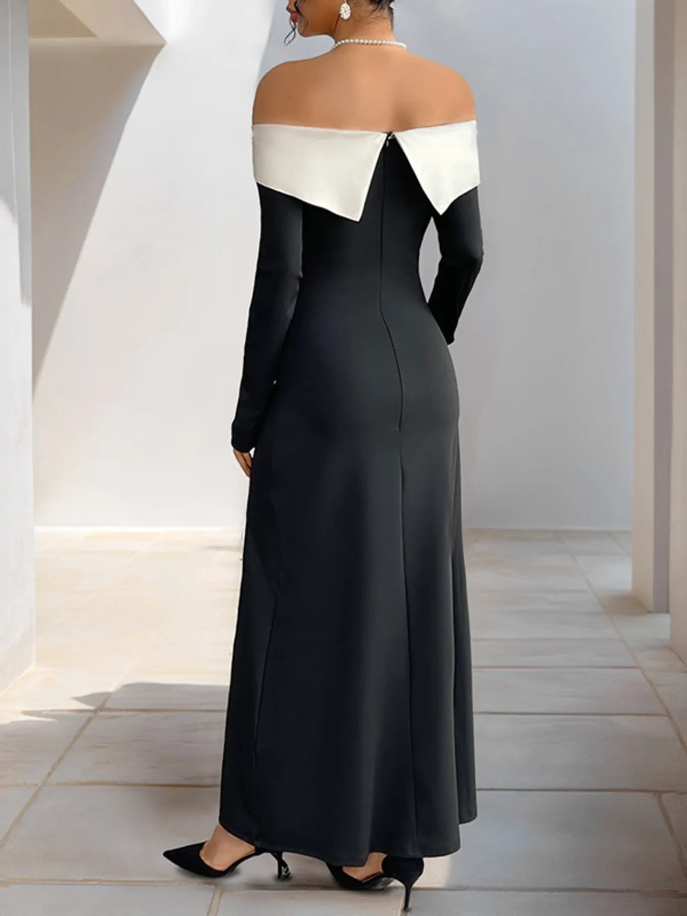 Black off-shoulder maxi dress with contrast neckline panel and side slit at hem