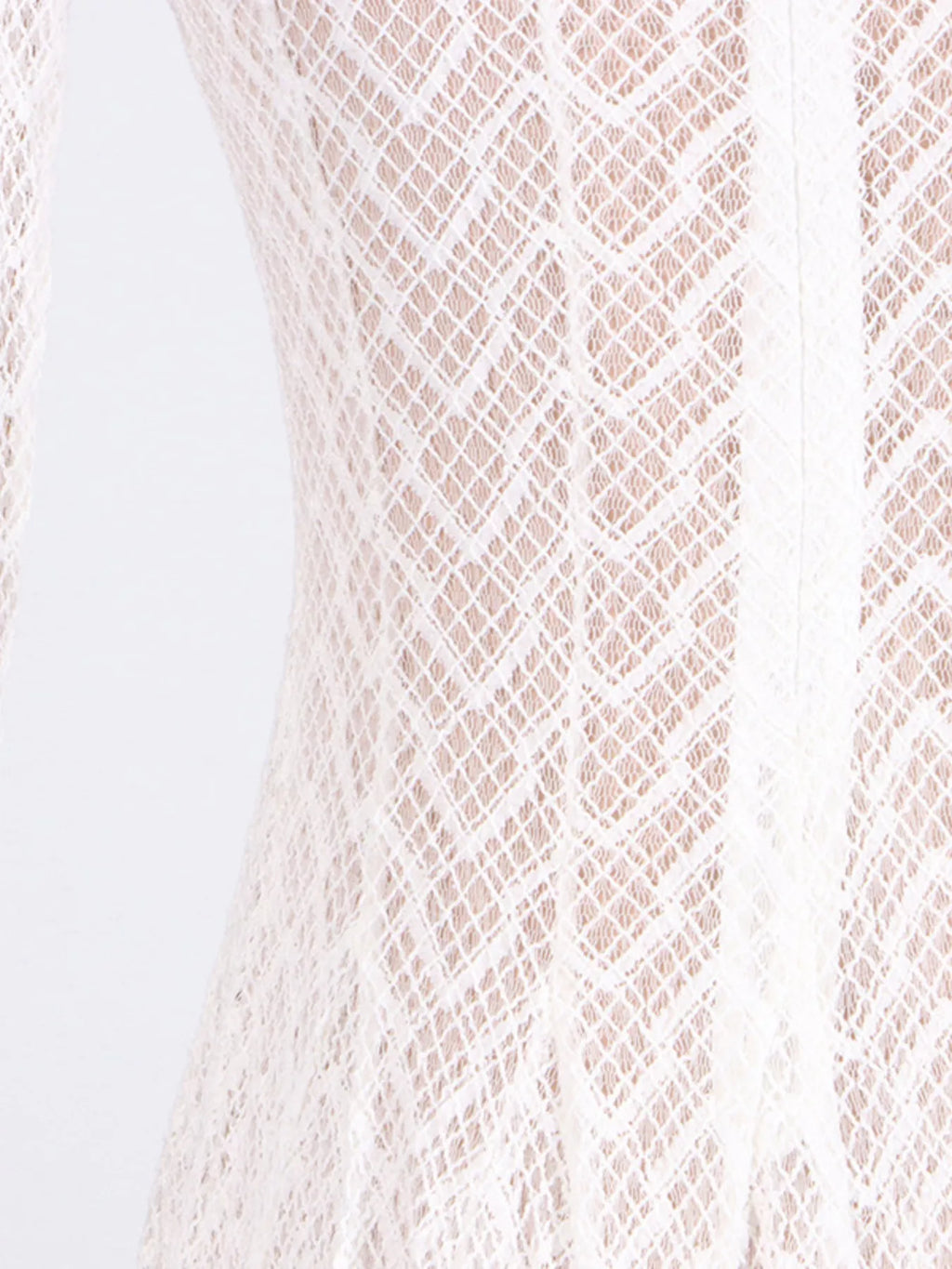 White lace dress fabric close-up at waist and skirt, textured diamond motif