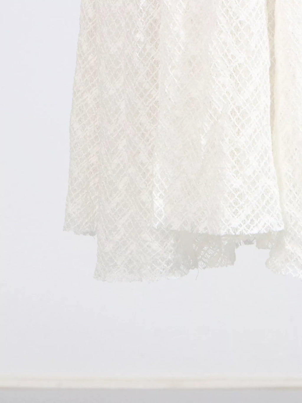 White lace maxi dress hem with layered sheer finish
