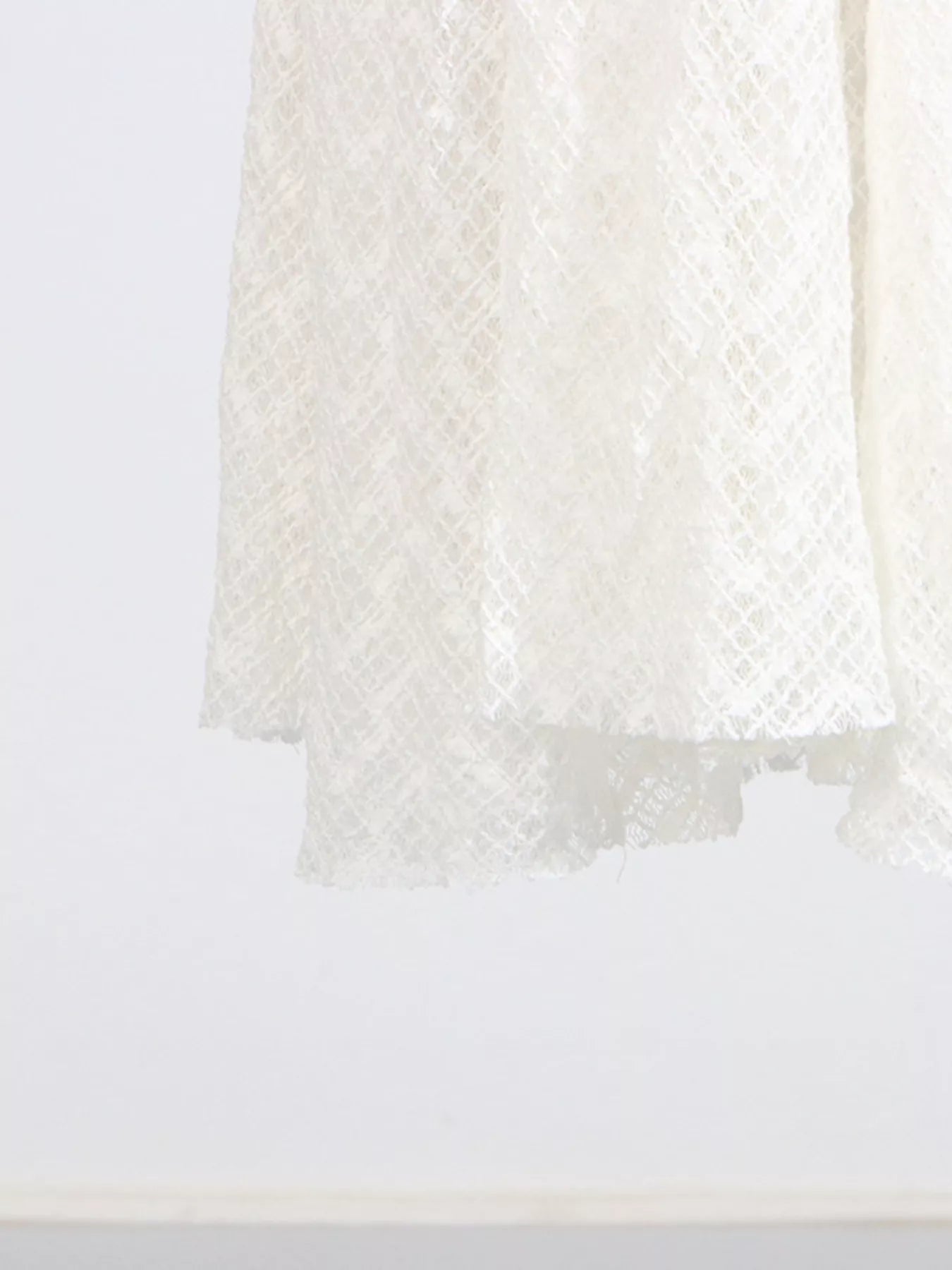 White lace maxi dress hem with layered sheer finish