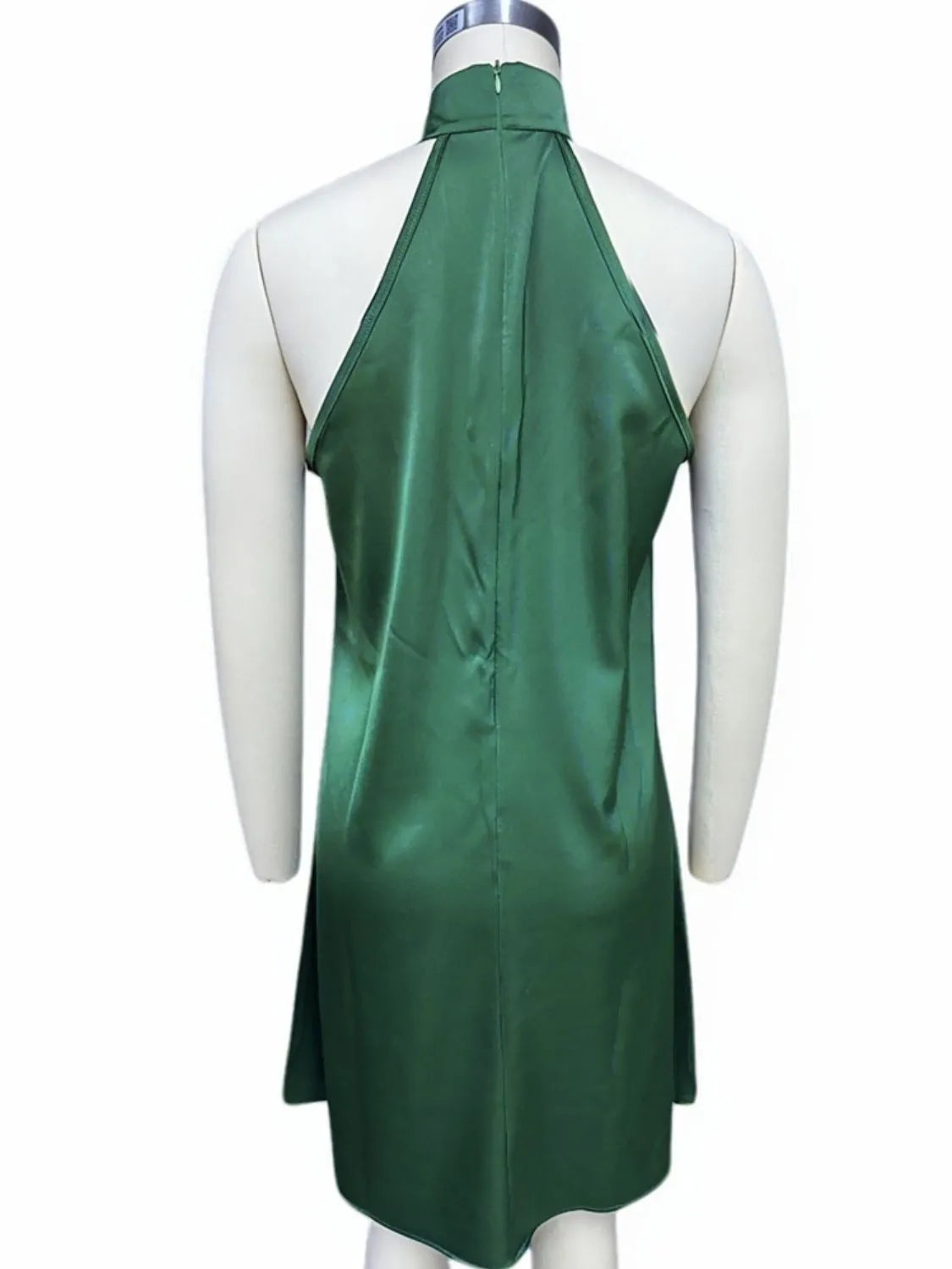 Dark green satin halter mini dress on mannequin, open back and neck tie