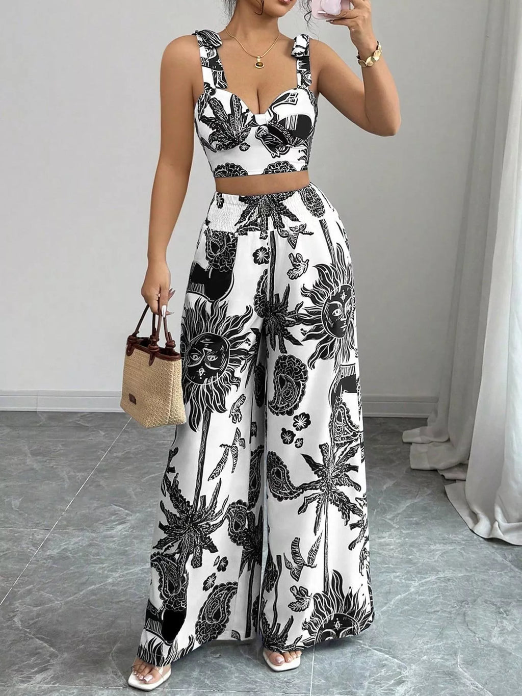 Black-and-white floral print sleeveless crop top and wide-leg pants set, adjustable waist