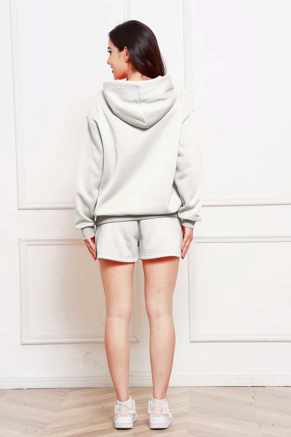 Light gray hooded sweatshirt with drawstring shorts set, back view.