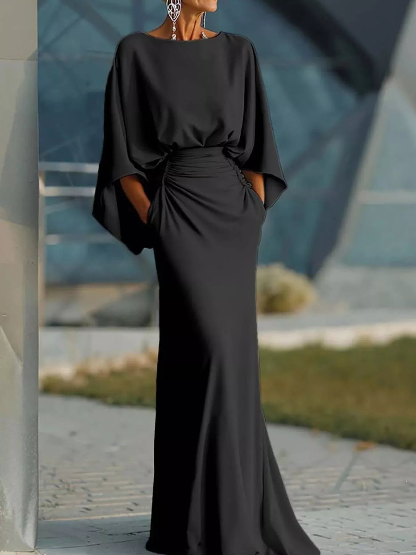 Black satin maxi dress with batwing sleeves and ruched waist, draped skirt