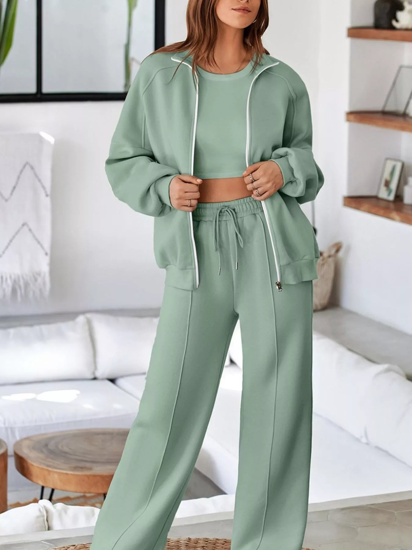 Sage green zip-up jacket and drawstring pants set, front view on model