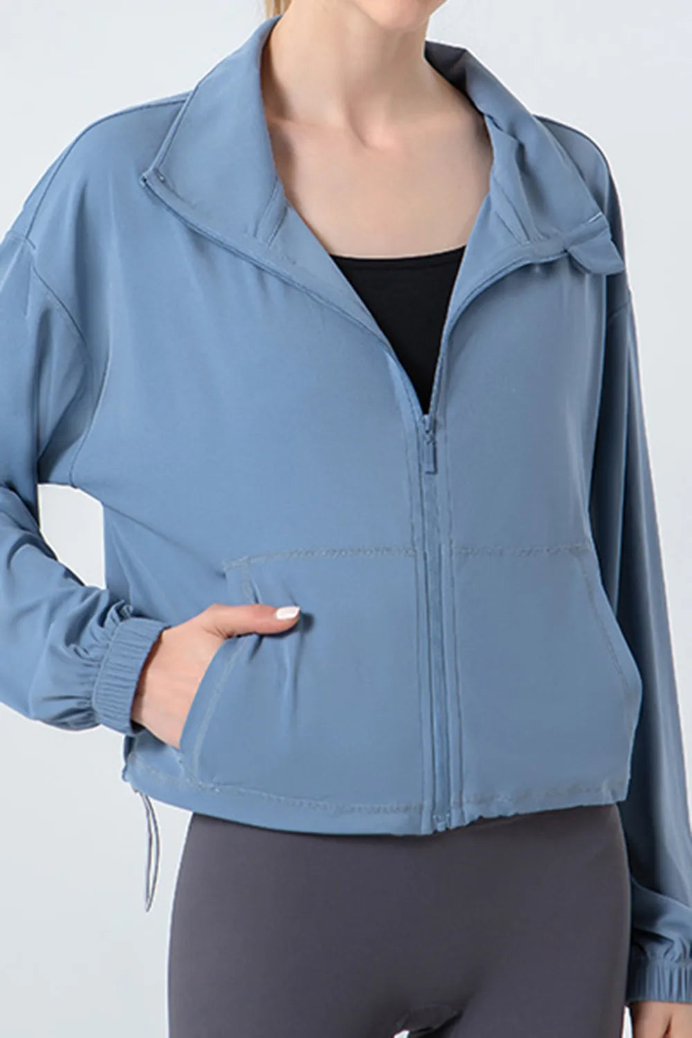Light blue zip-up active jacket with stand collar, front zipper, dropped shoulders