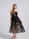 Black strapless midi dress with layered floral applique on sheer mesh skirt