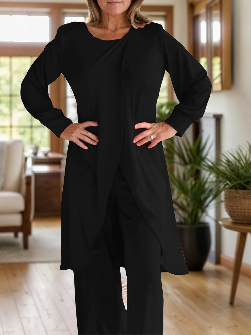 Two-piece slit top and pants set, black, long sleeves and round neck, front view.