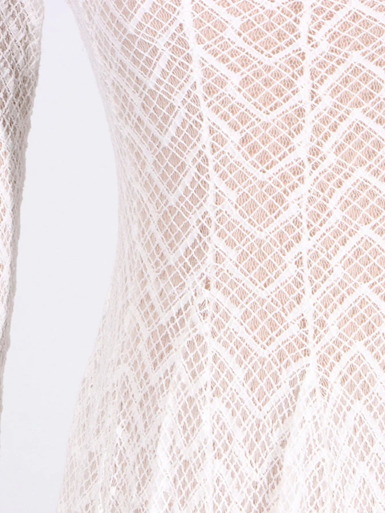 White lace dress fabric close-up with repeating geometric diamond pattern