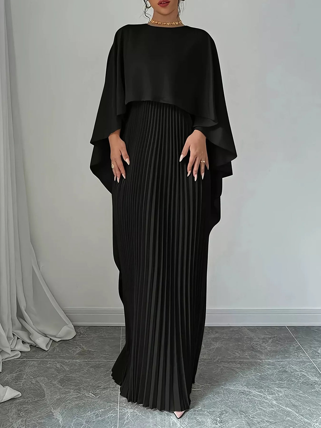 Black cape pleated maxi dress with layered cape sleeves and long pleated column skirt
