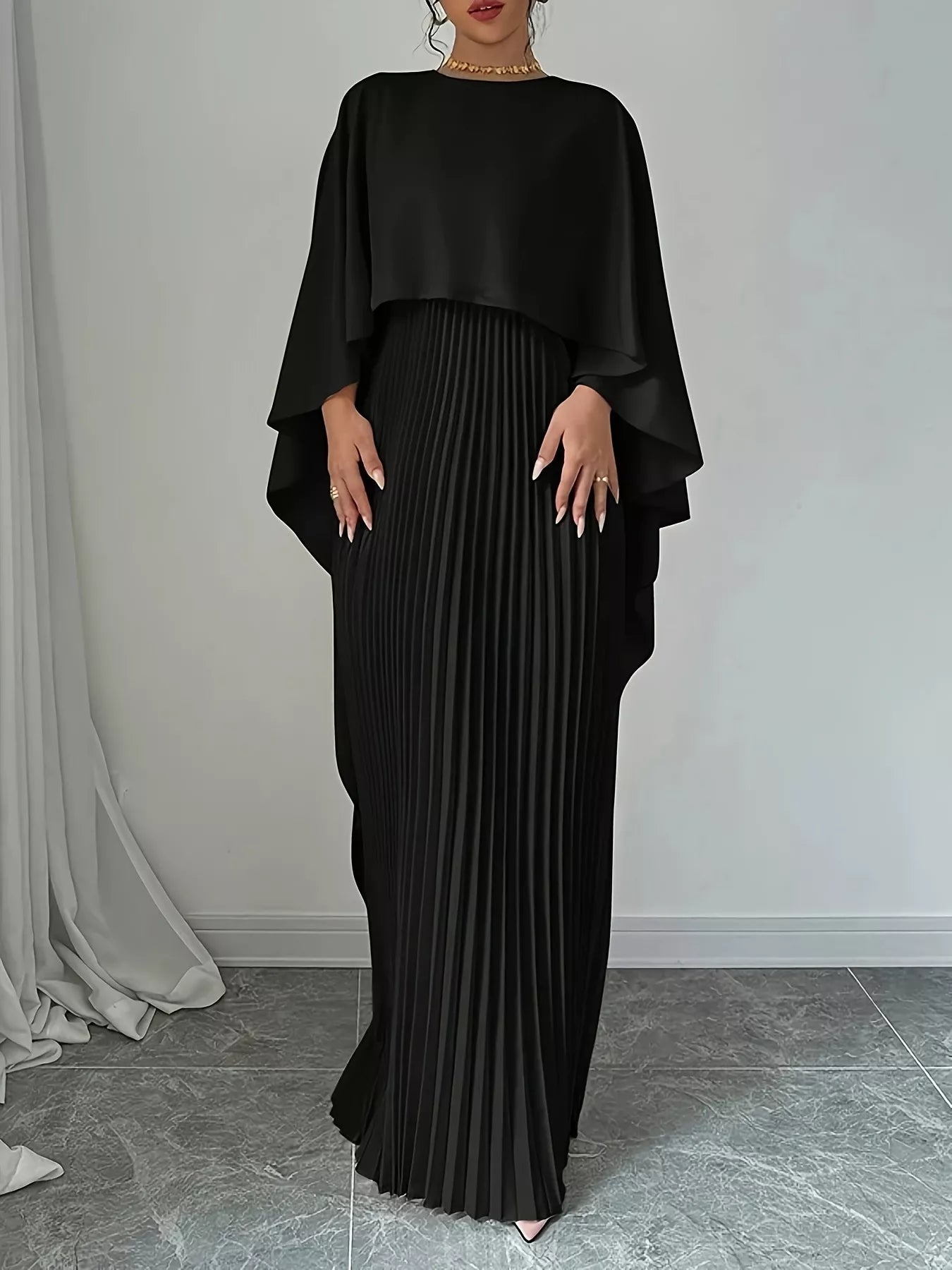 Black cape pleated maxi dress with layered cape sleeves and long pleated column skirt