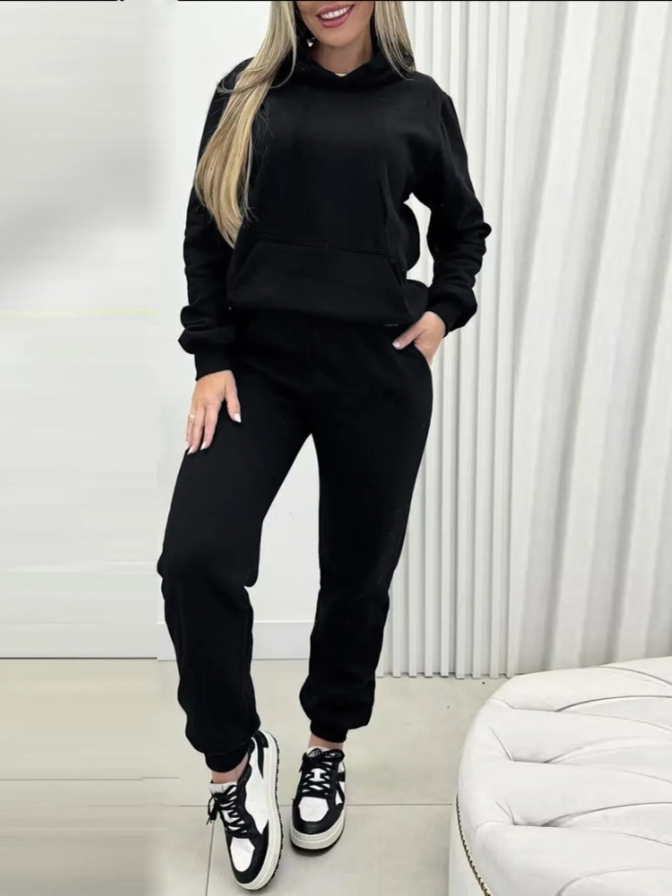 Black long-sleeve hoodie and joggers set with hood, drawstring, and front pocket