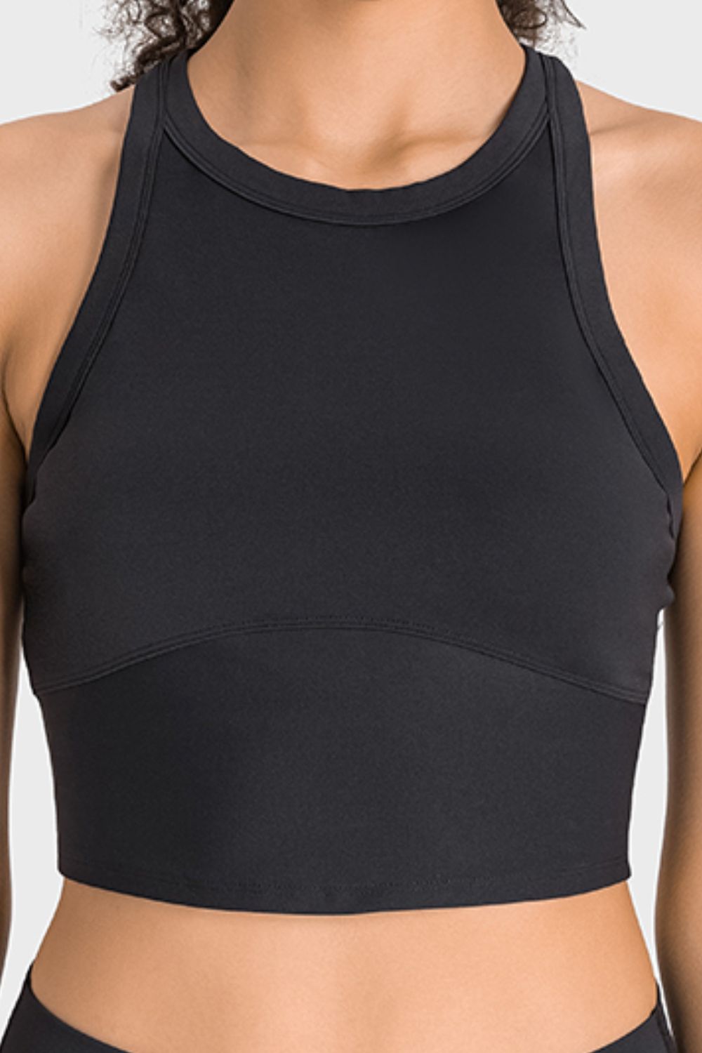 Black racerback cropped sports tank with round neckline and stitched seams.