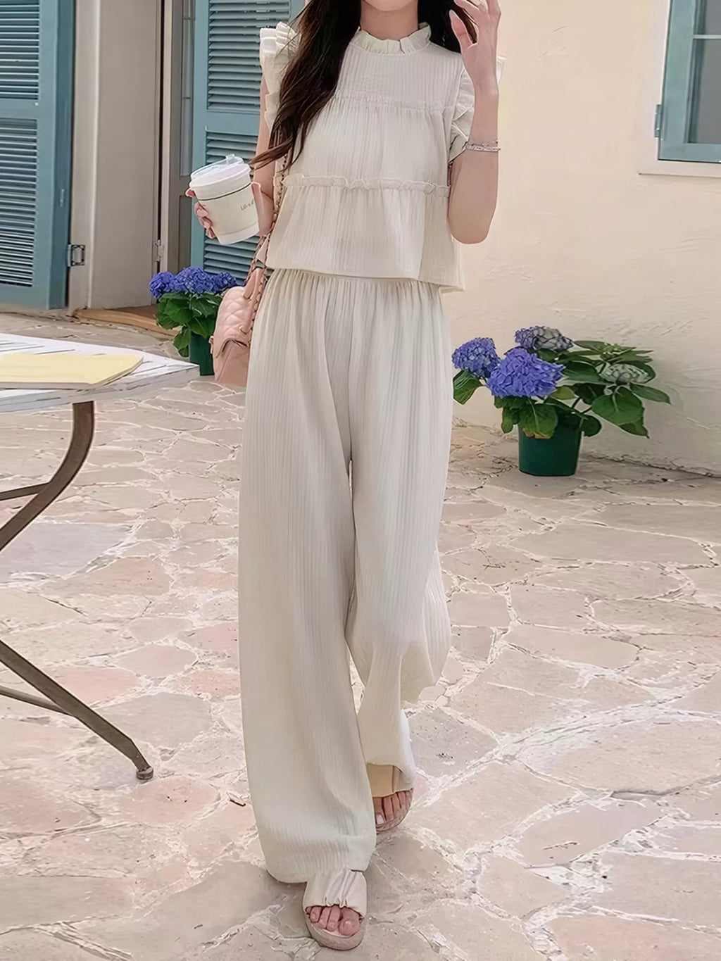Apricot ruffled sleeveless top and wide-leg pants set with vertical texture