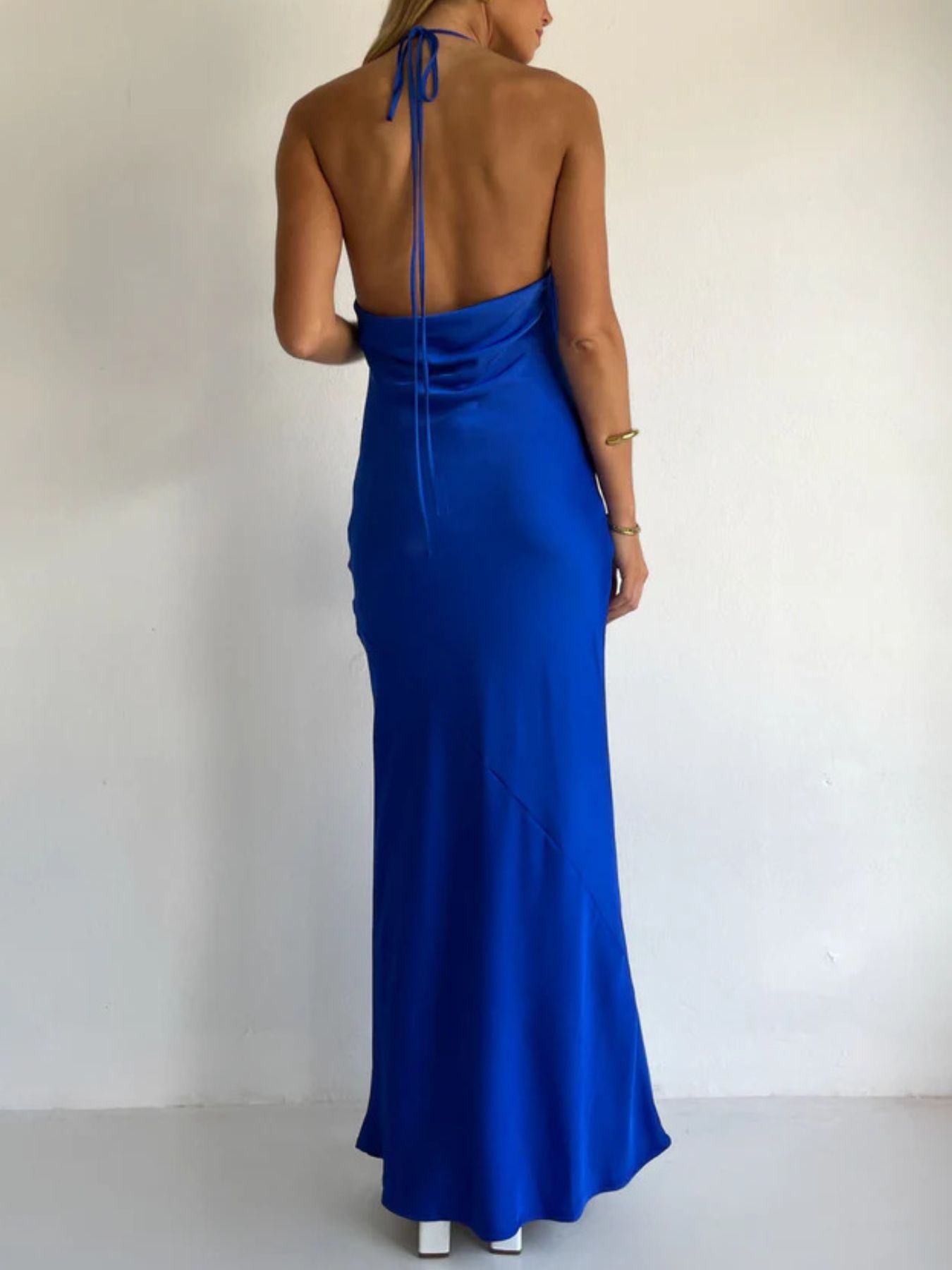 Blue satin halter maxi dress with open back and tied halter straps