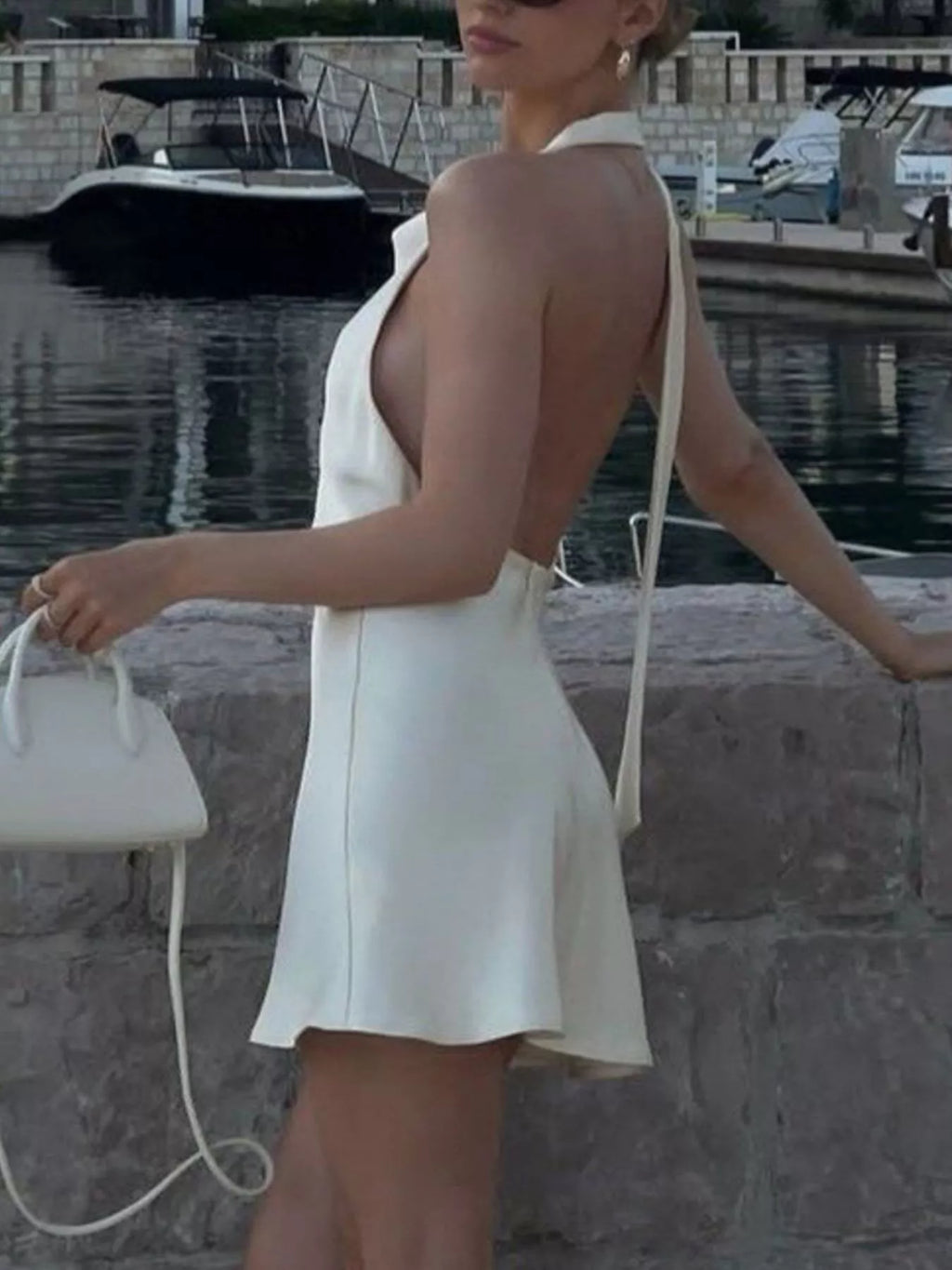 White halter neck mini dress with open back and V-back straps, A-line skirt