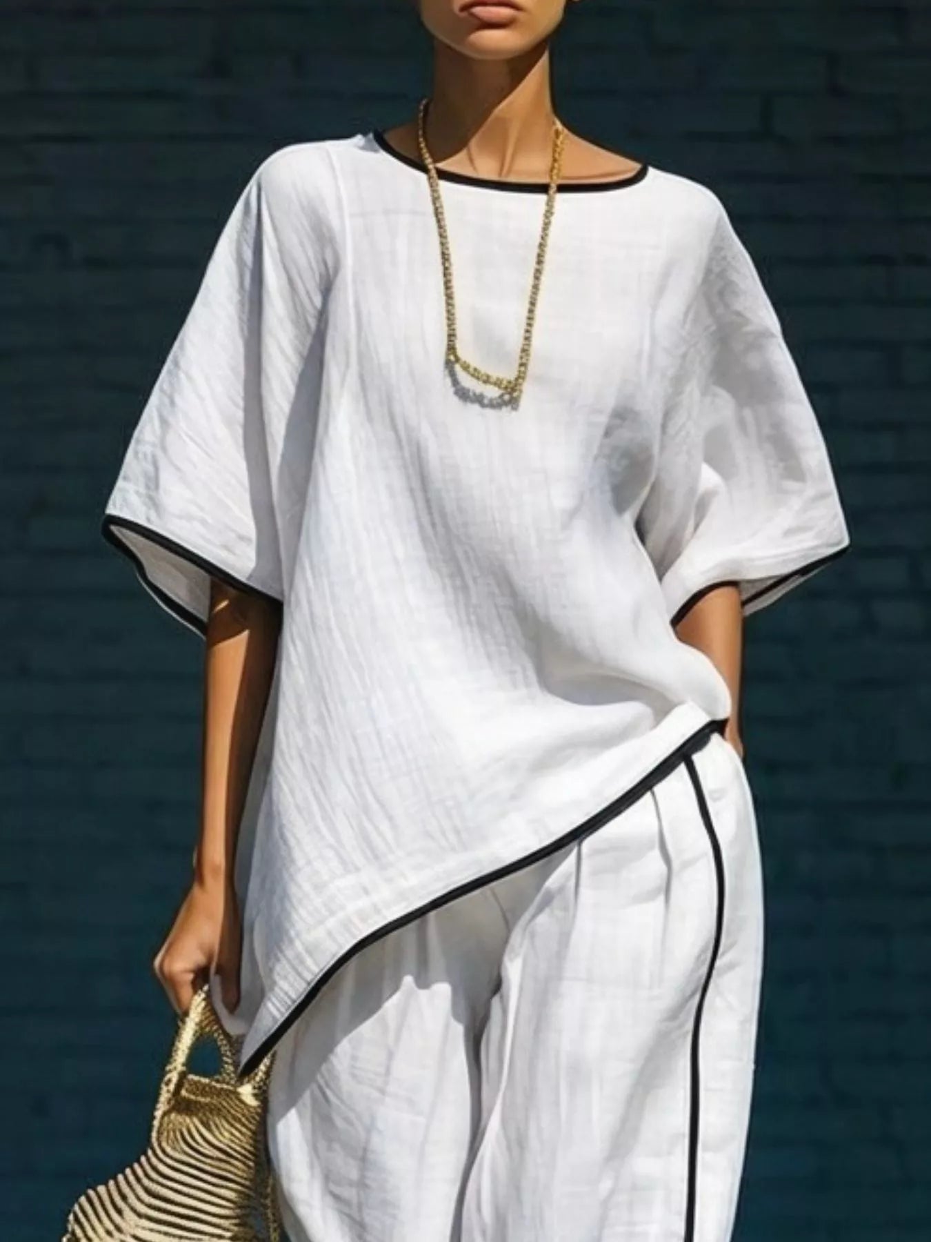 White round-neck top and wide-leg pants set with black-trim diagonal hem detail