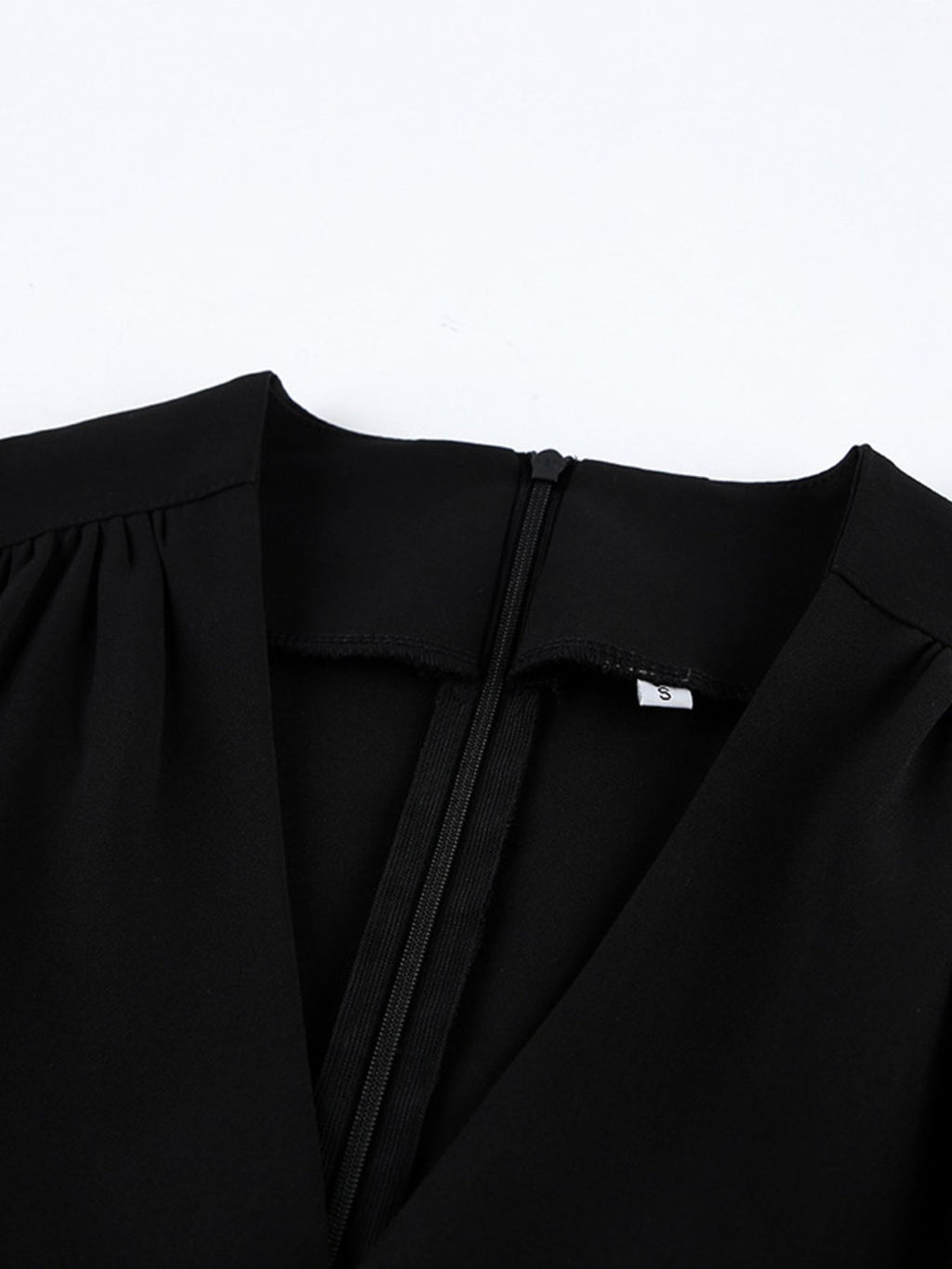 Black surplice V-neck dress with gathered neckline and smooth seam detailing.