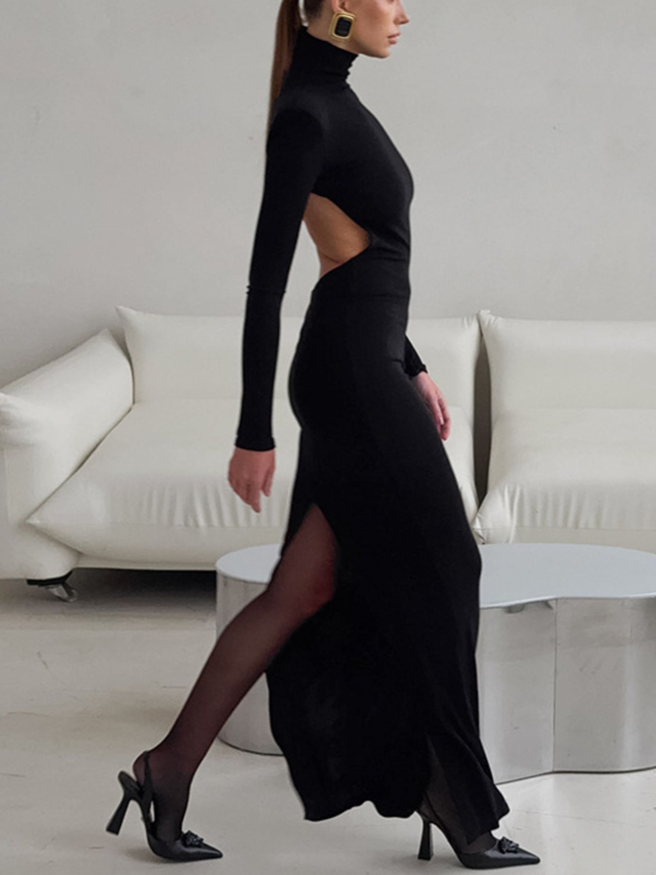 Black turtleneck long-sleeve bodycon maxi dress with side slit and open-back cutout