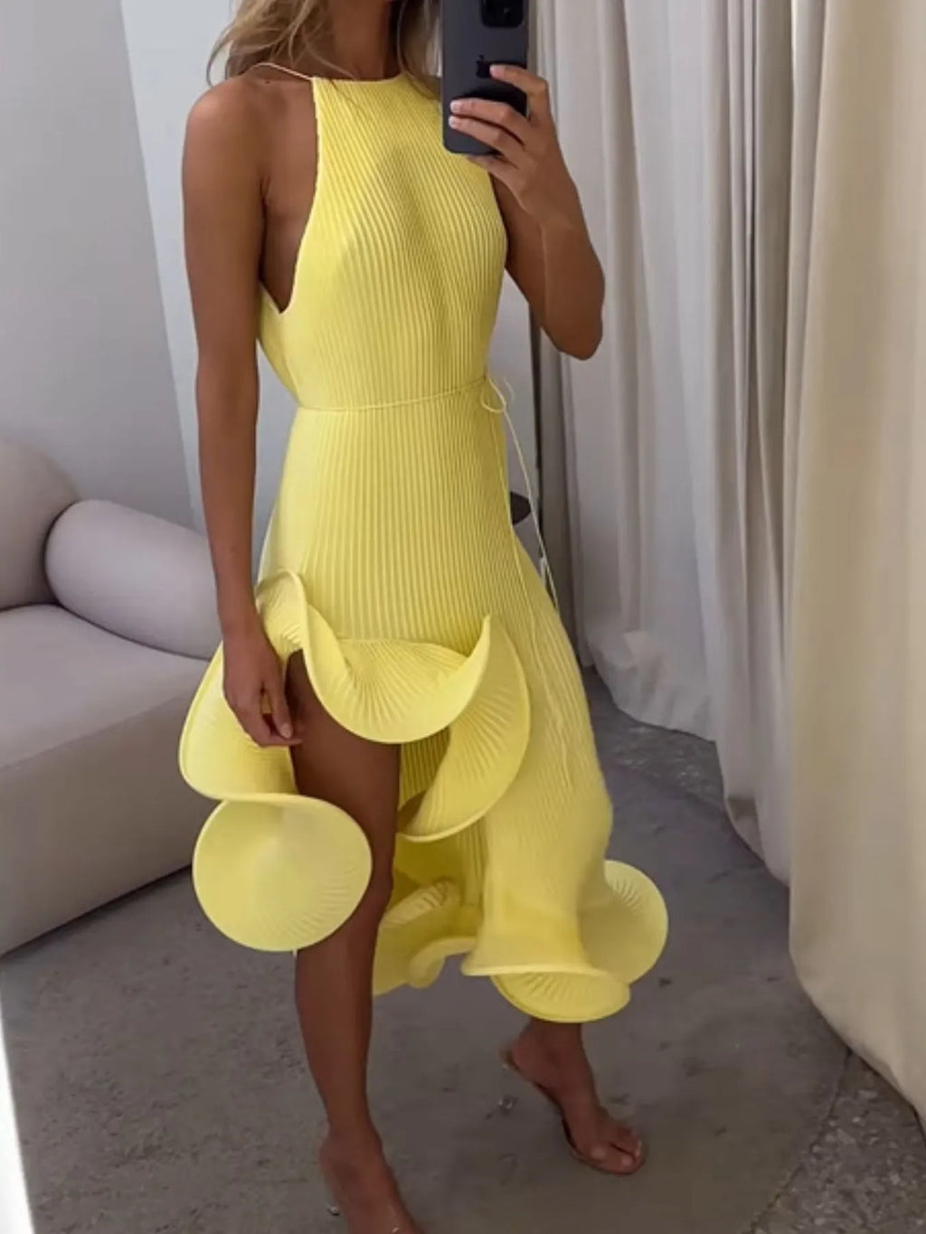 Yellow ribbed sleeveless dress with ruffle hem and fitted waist, tiered flutter layers