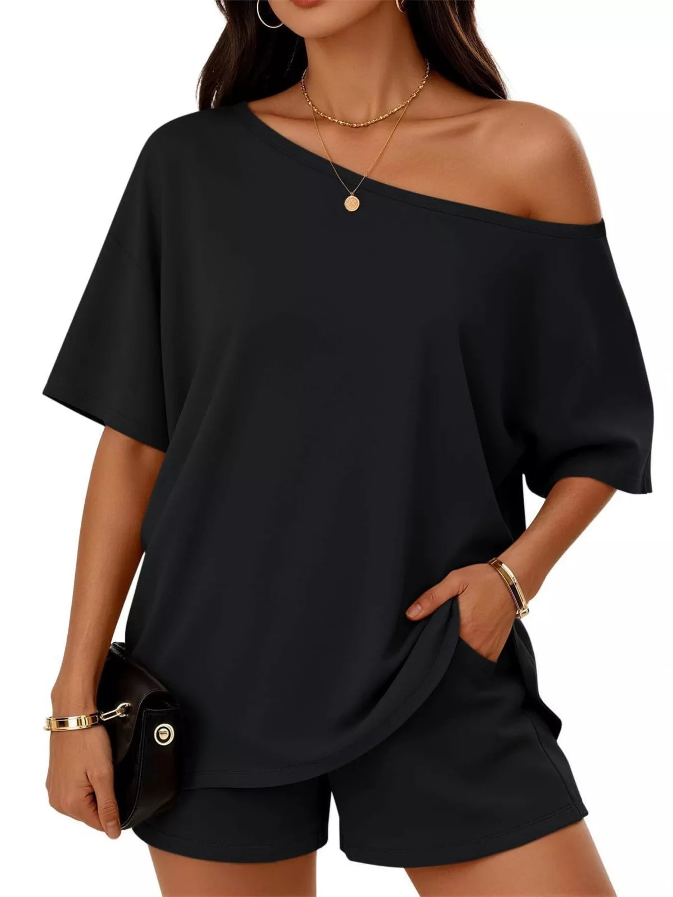 Plus size one-shoulder black top and shorts set with diagonal neckline and relaxed draped fit