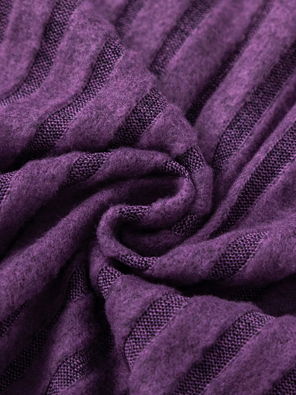 Purple ribbed knit fabric knot detail, sweater texture close-up