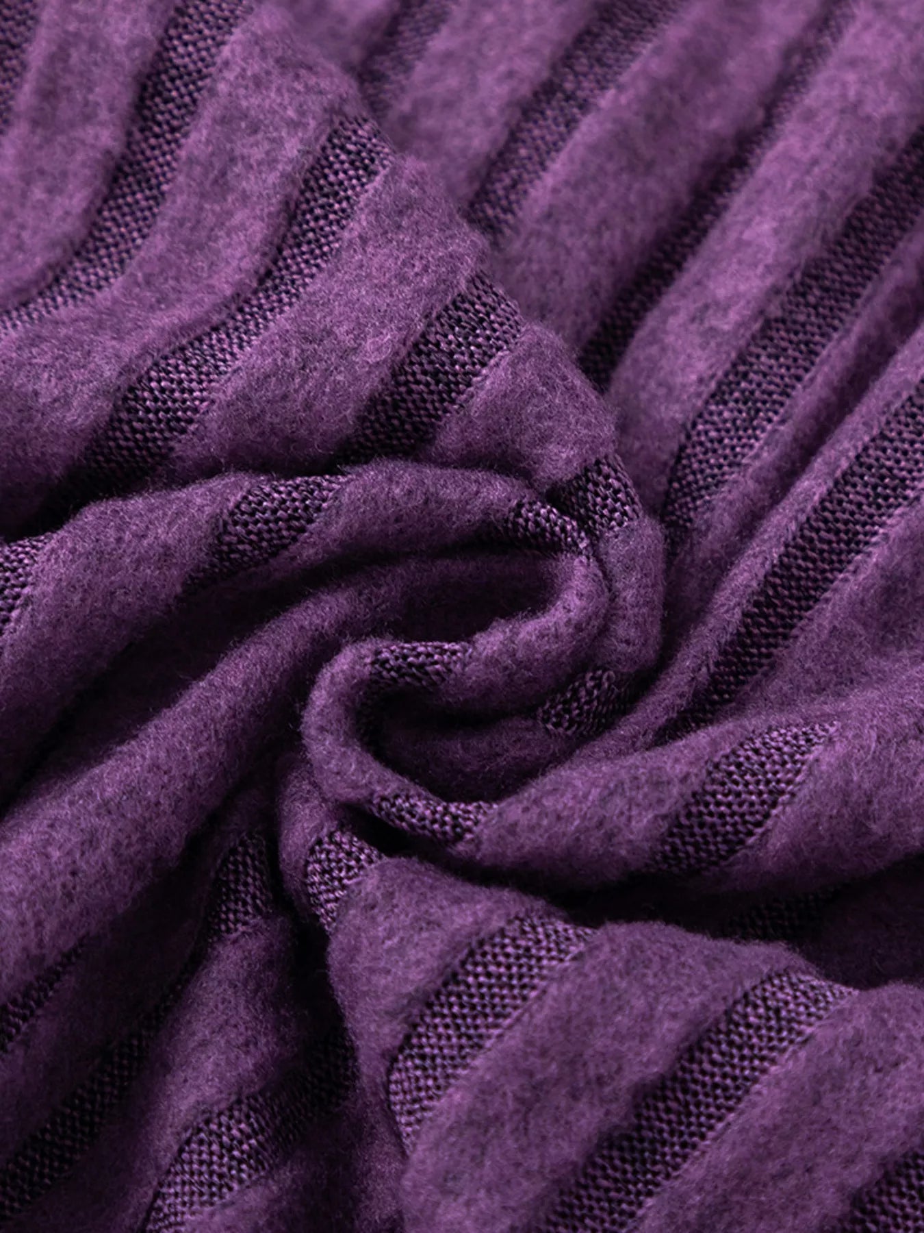 Purple ribbed knit fabric knot detail, sweater texture close-up