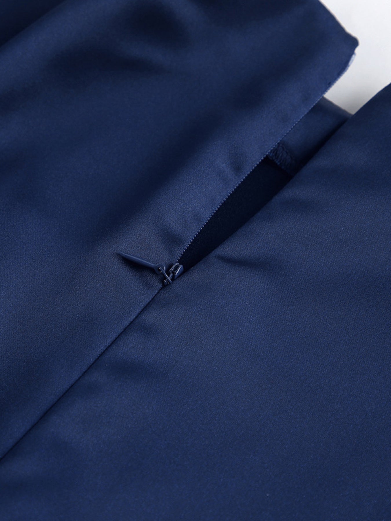 Navy cape sleeve mini dress close-up of side slit opening and snap/fastener