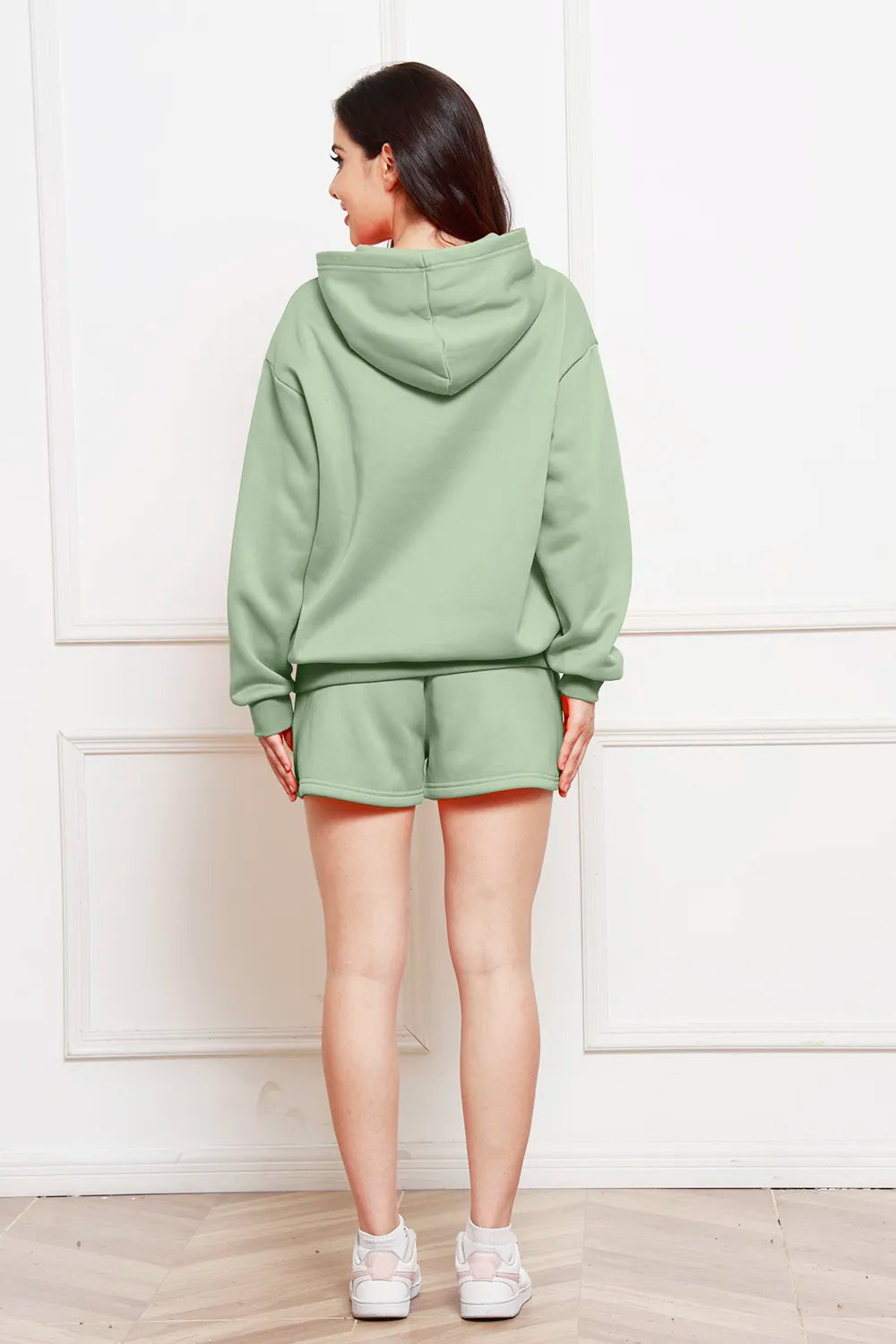 Sage green hooded sweatshirt and drawstring shorts set, back view.