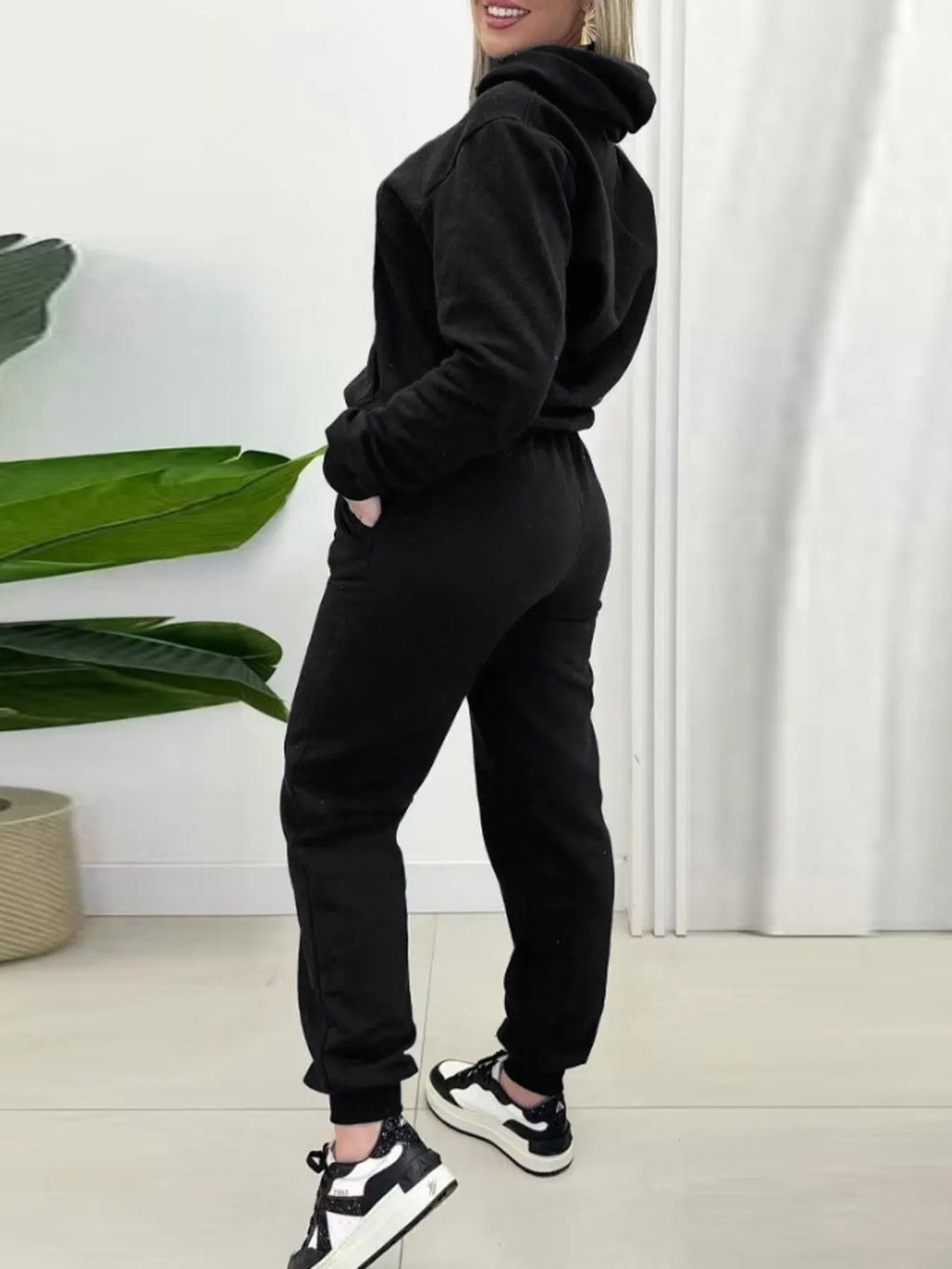 Black two-piece long-sleeve hoodie and joggers set with ribbed cuffs and drawstring