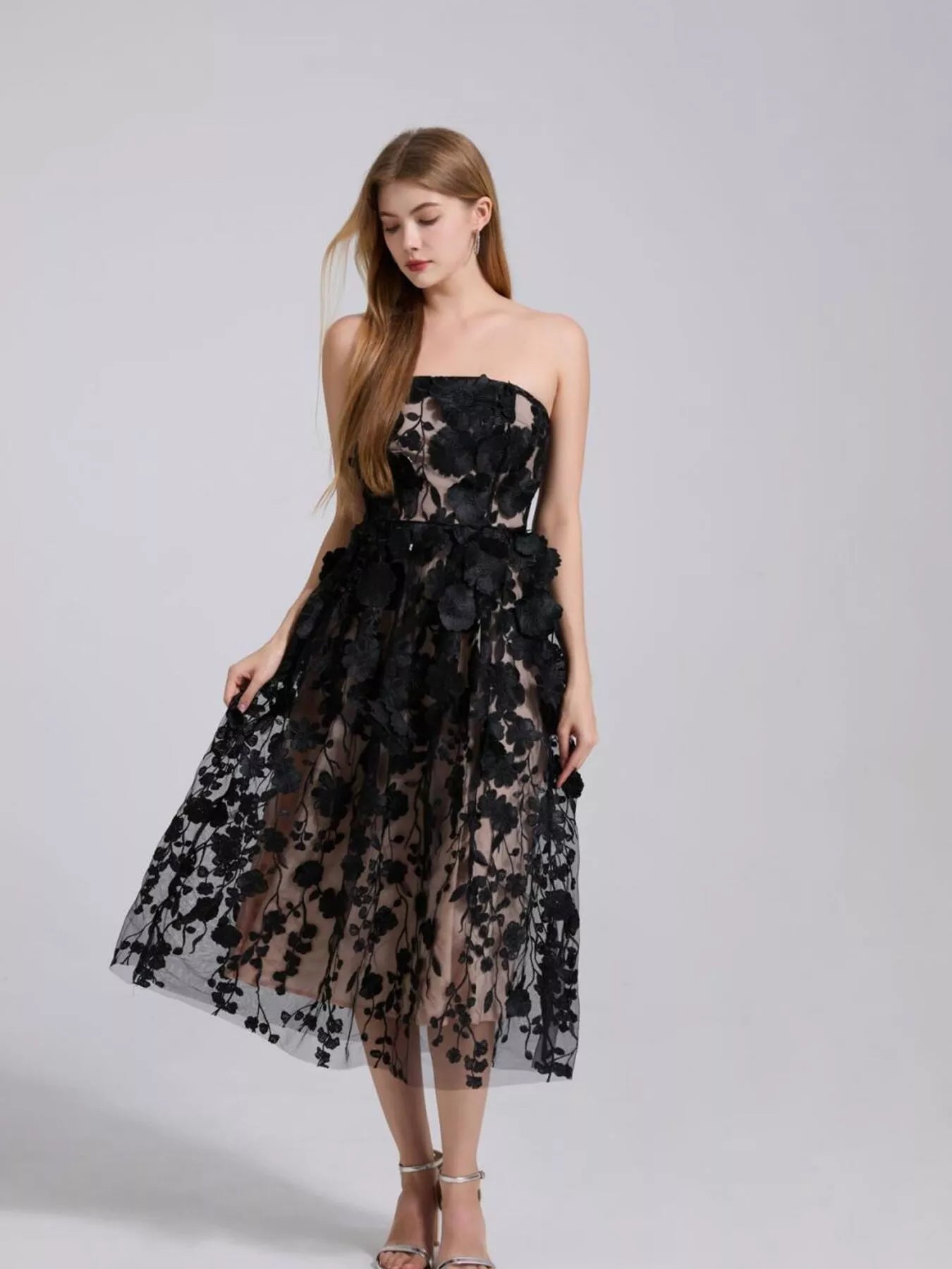 Black strapless midi dress with layered floral applique and airy tulle skirt