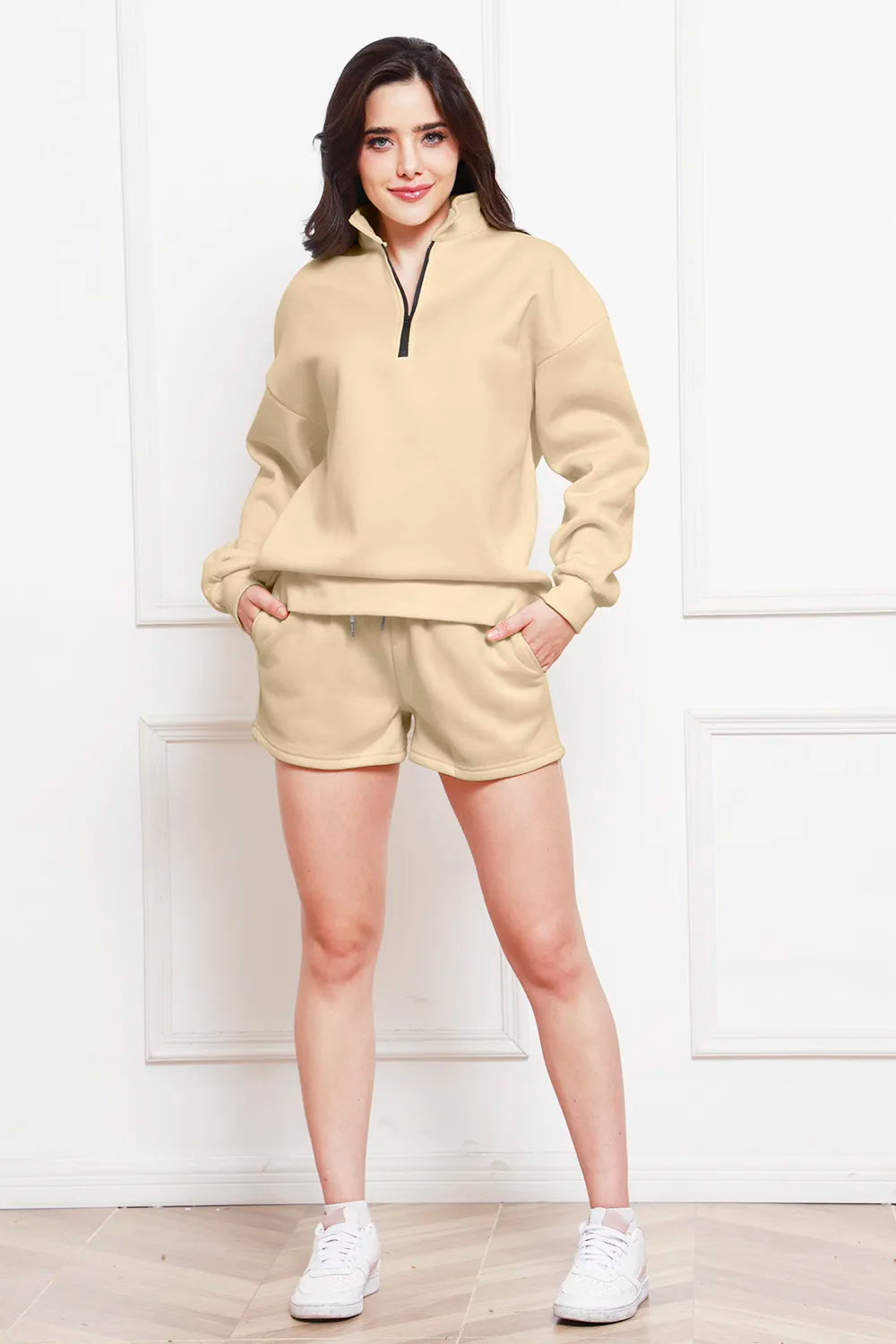 Ivory half-zip long-sleeve sweatshirt and matching drawstring shorts set.