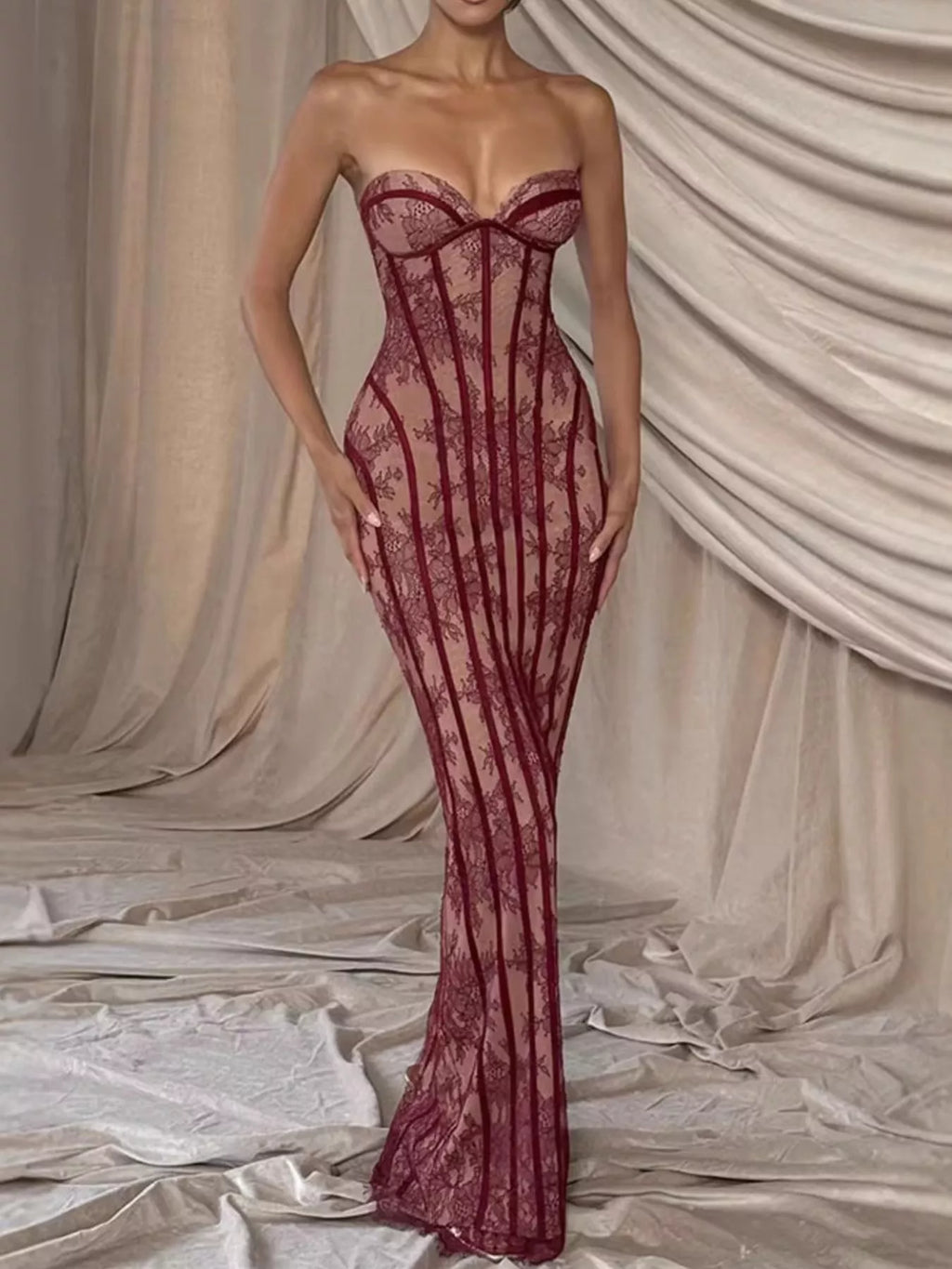 Burgundy lace-up back strapless maxi dress with corset-style seams and flowing lace hem