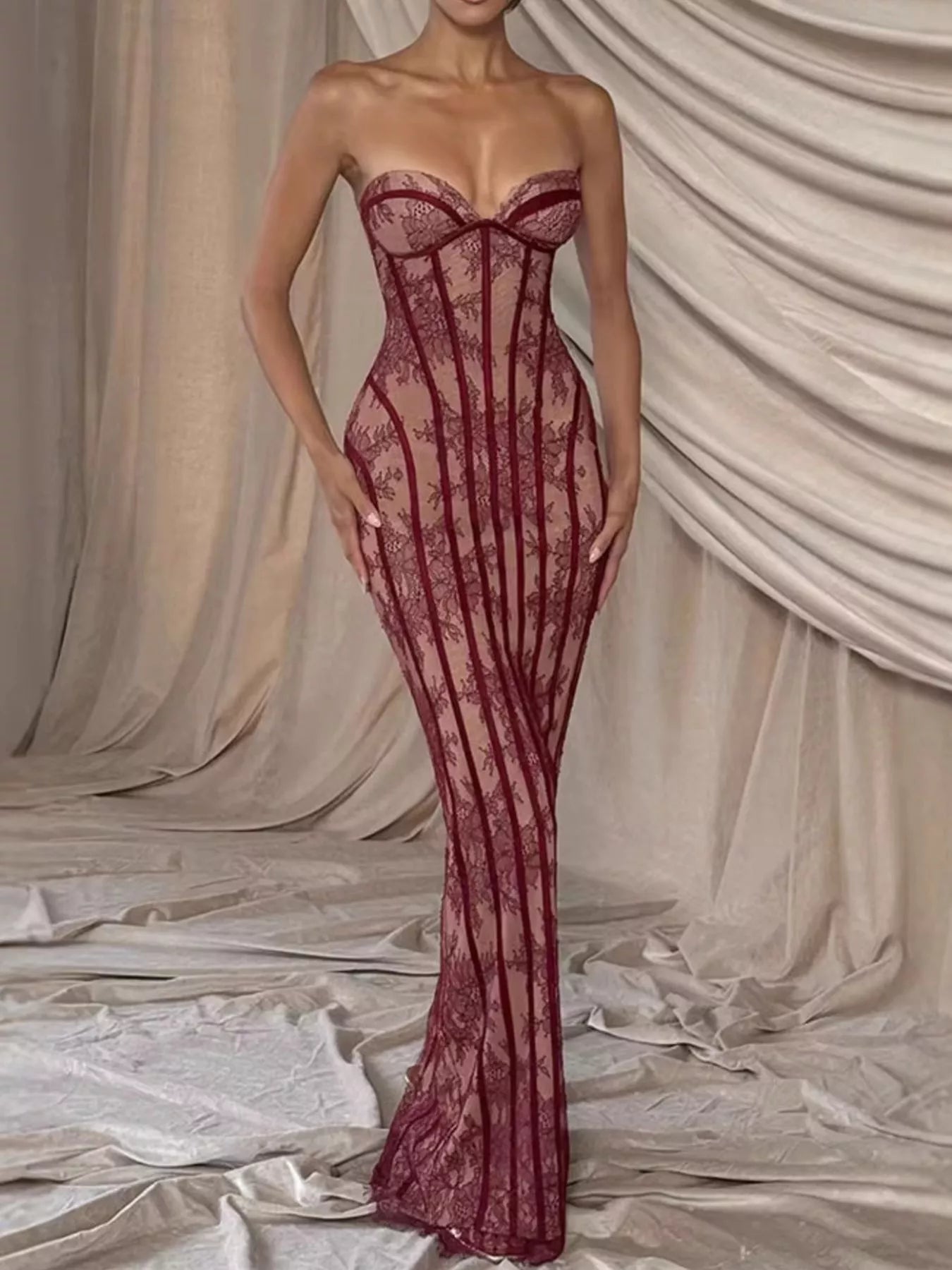 Burgundy lace-up back strapless maxi dress with corset-style seams and flowing lace hem