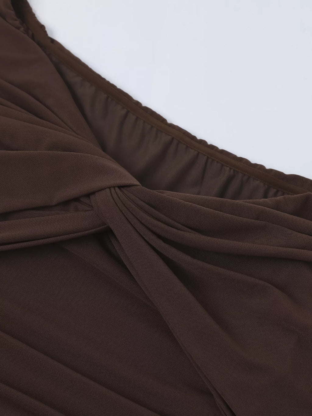 Close-up of brown off-shoulder neckline and gathered ruching detail