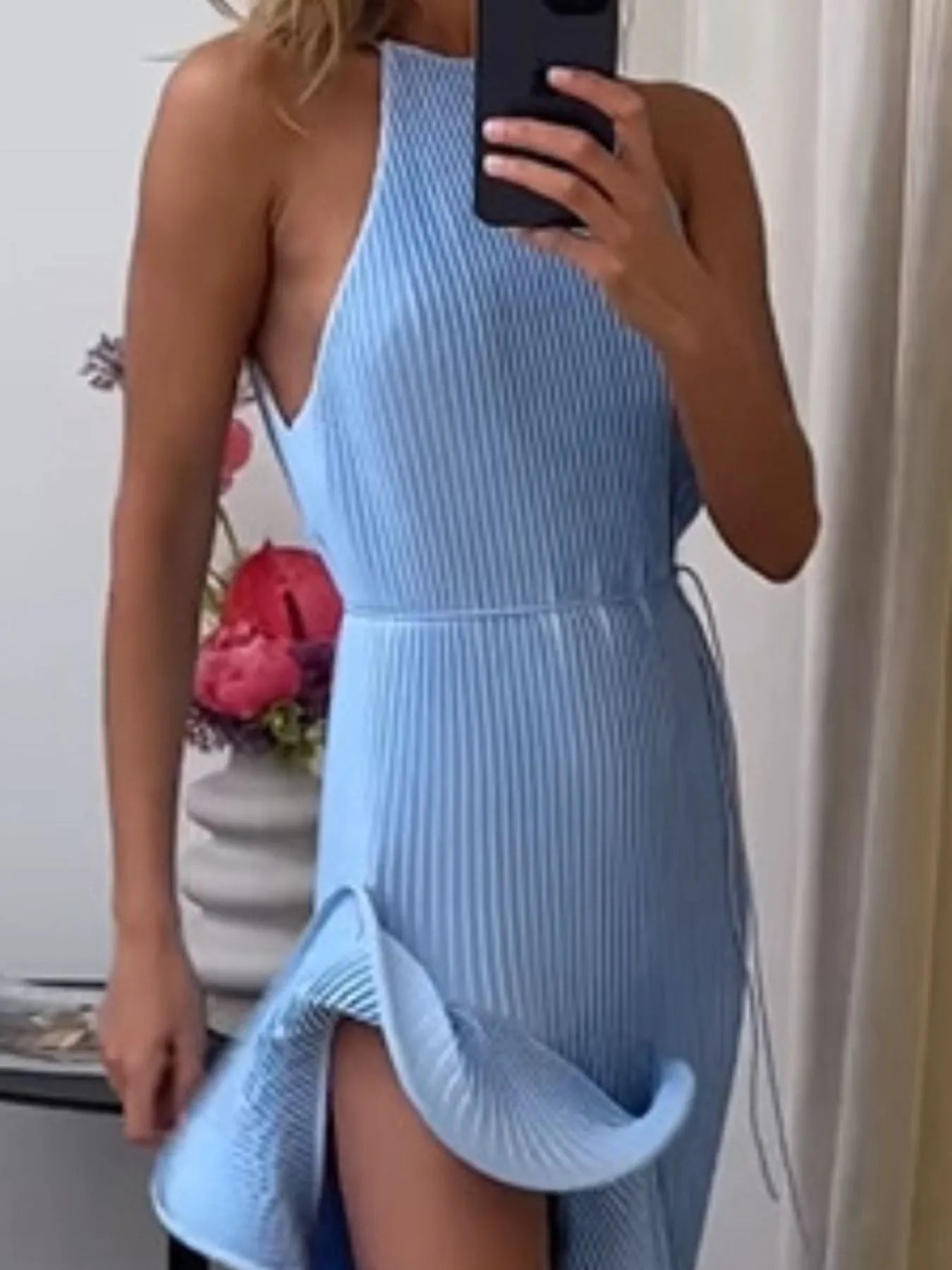 Blue ribbed sleeveless dress with ruffle hem and fitted waist, front slit detail