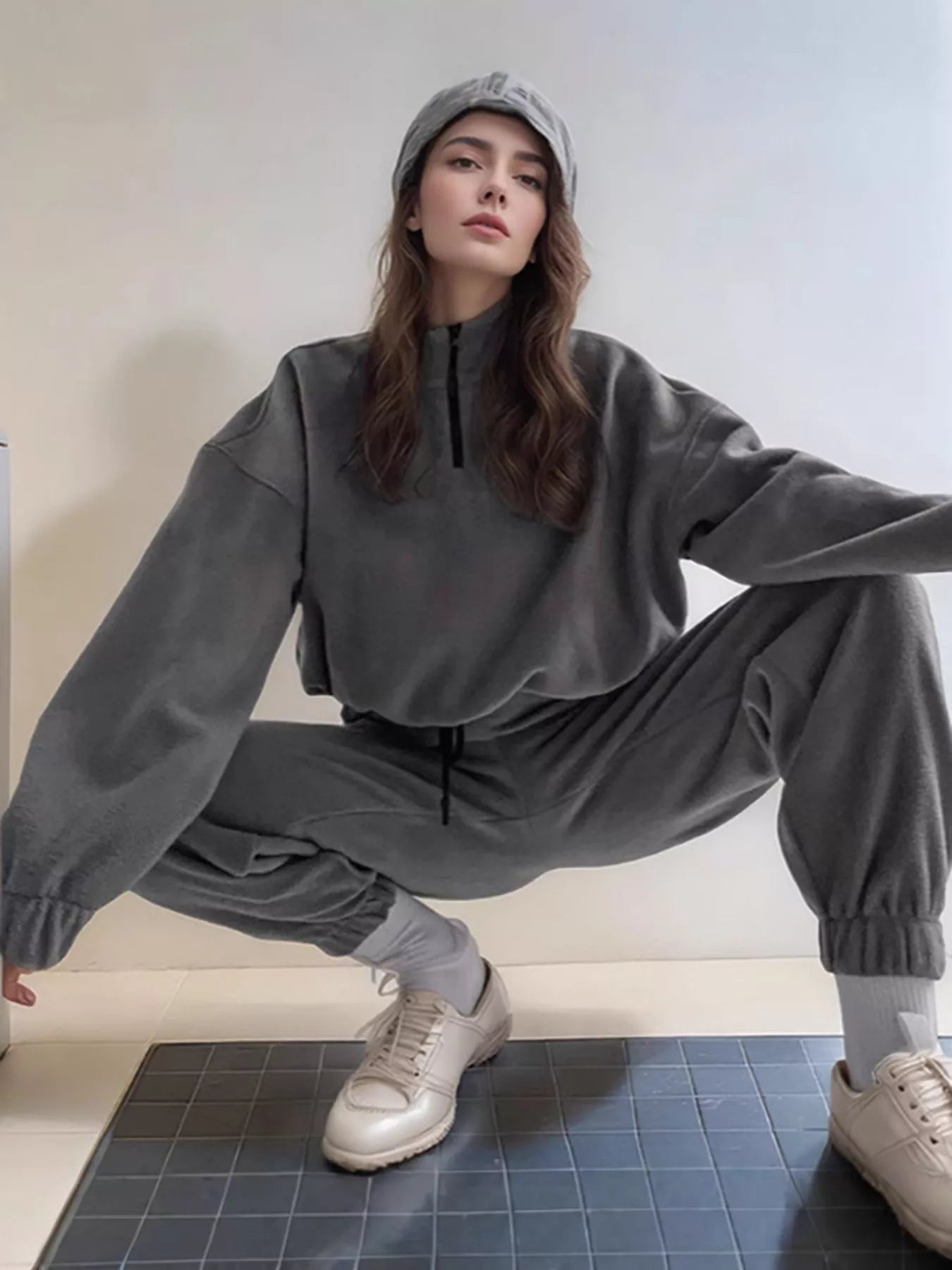 Dark gray quarter-zip sweatshirt with matching jogger pants, elastic cuffs