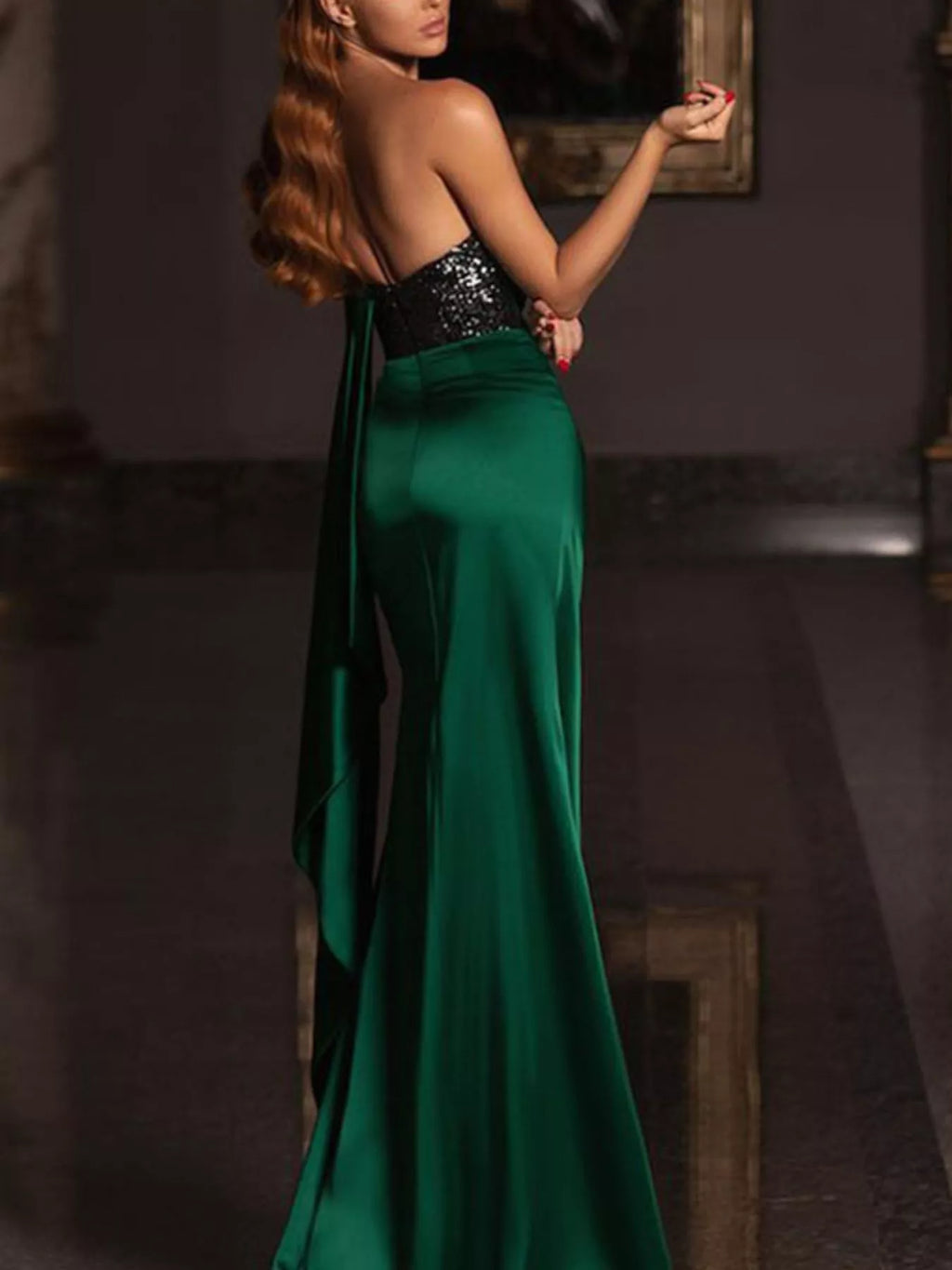 One-shoulder green satin gown with black sequin bodice and draped skirt