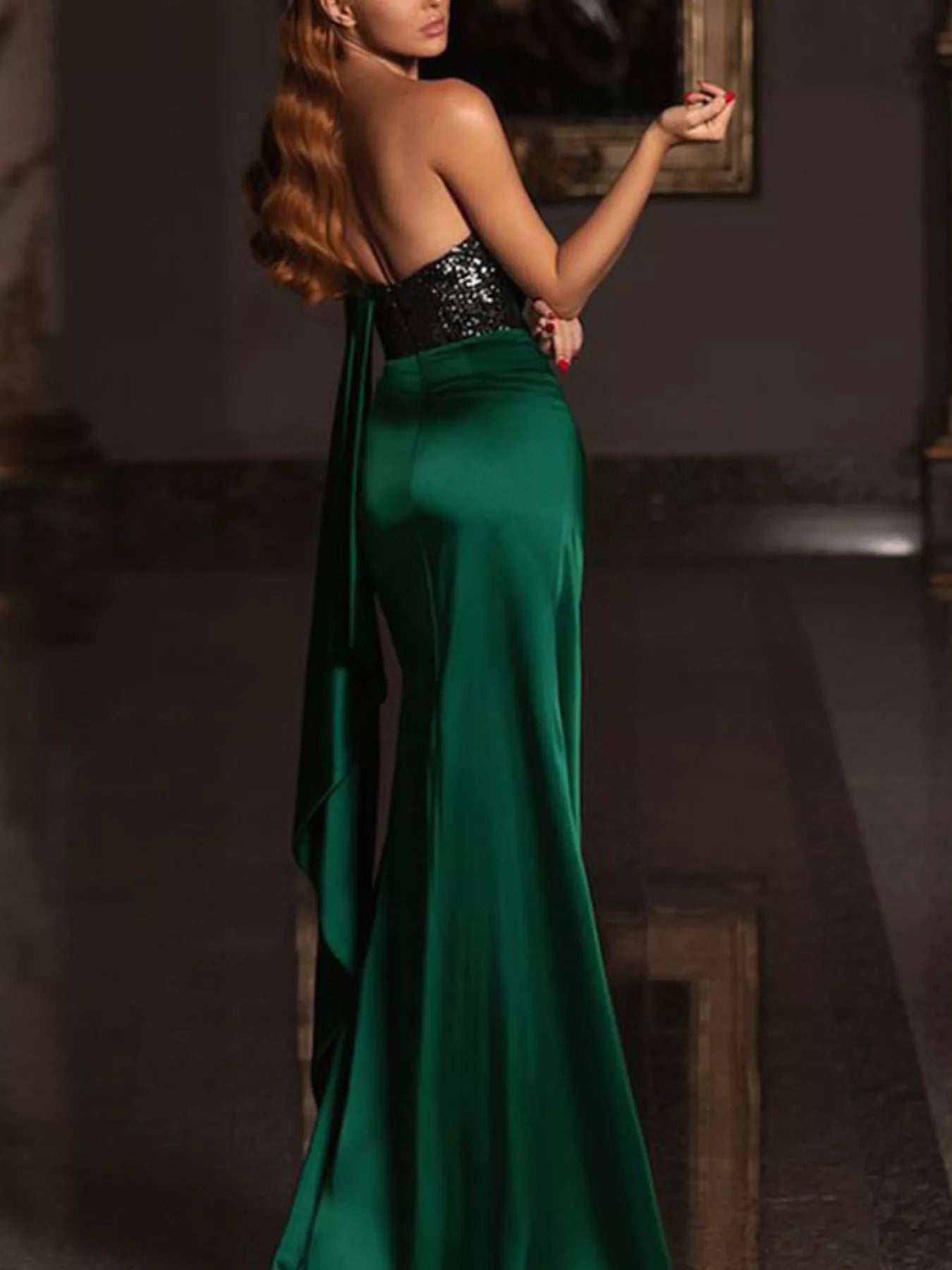 One-shoulder green satin gown with black sequin bodice and draped skirt