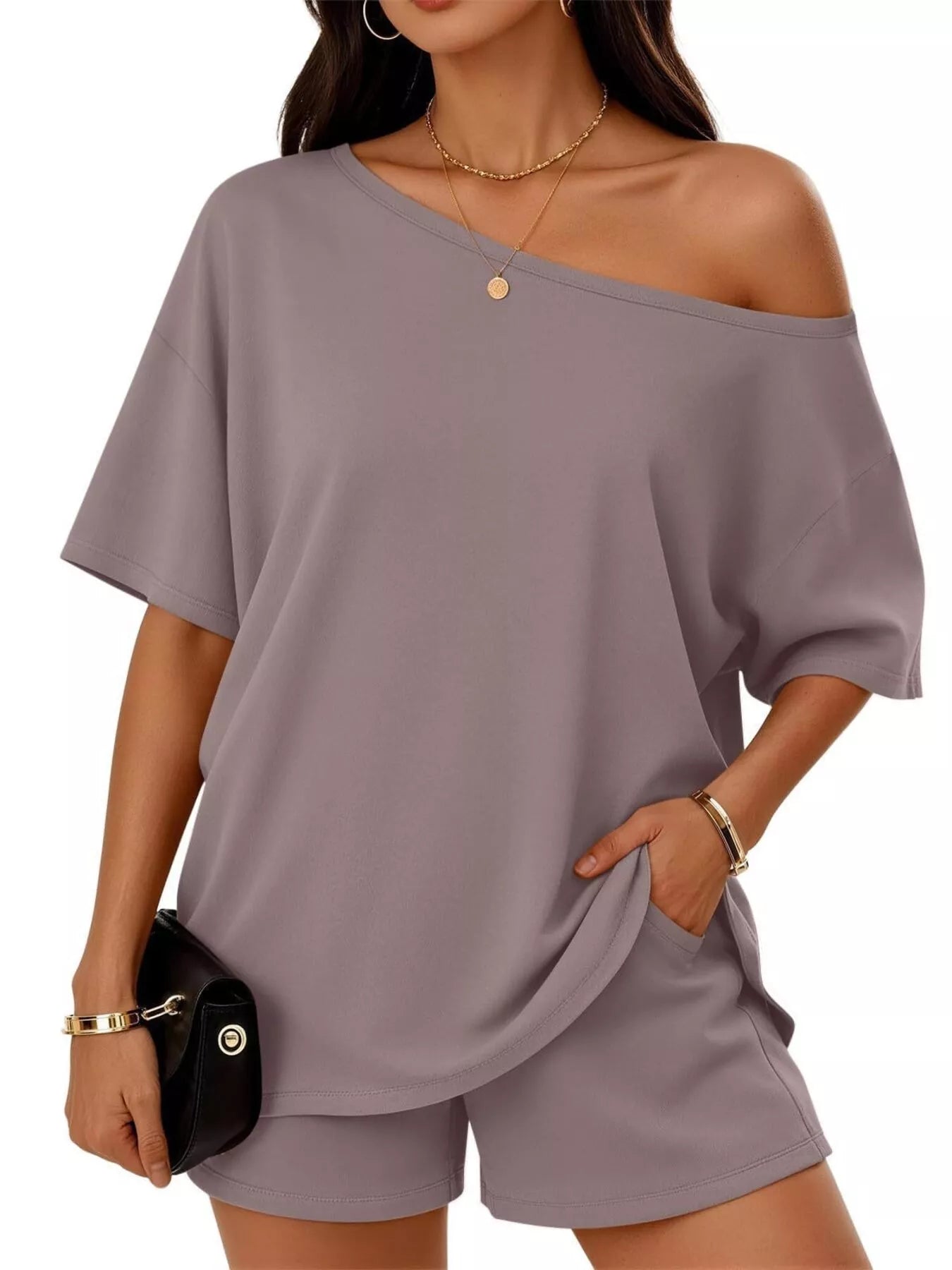 Mauve one-shoulder top and matching shorts set with draped shoulder and short sleeves.